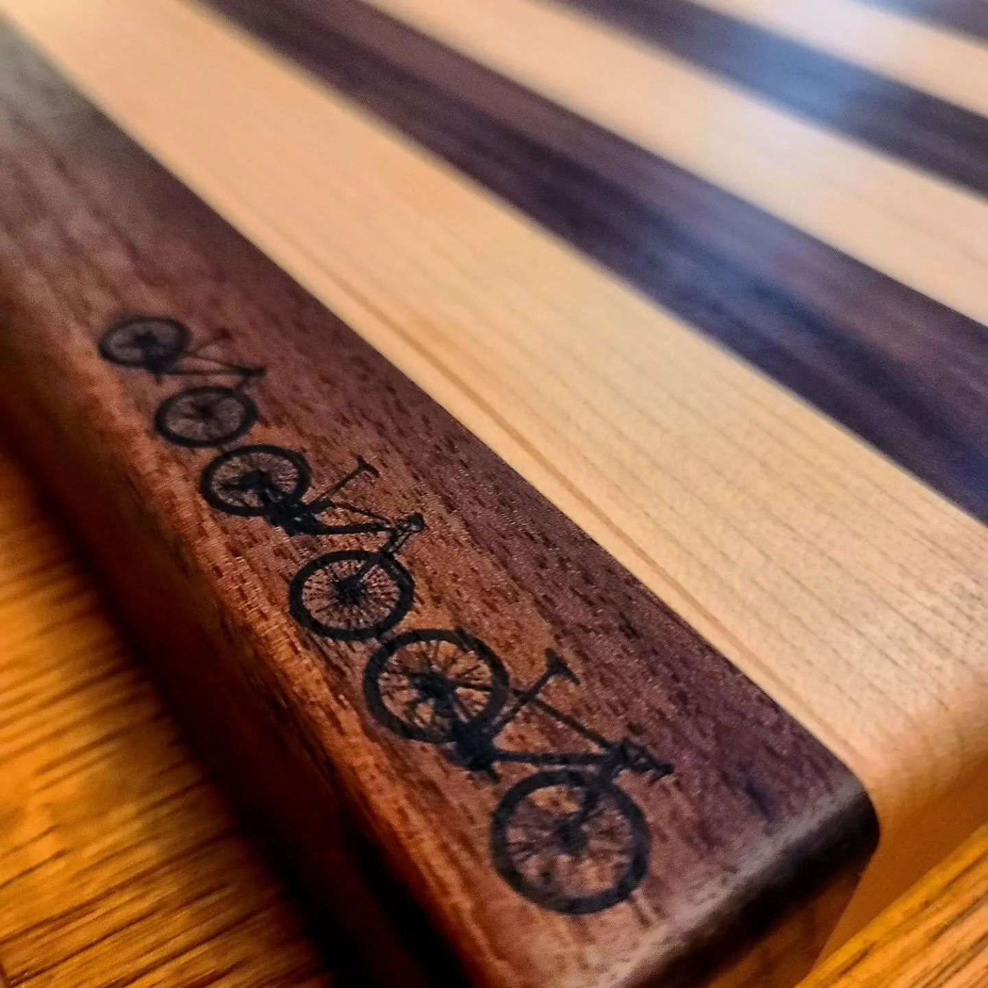 A commissioned  birthday gift for my brother, from @akrugenelra , he doesn't have instagram so I figured it was safe to post a couple days early 🤔
.
18"&times;13'&times;1.5" Walnut and Maple cutting board with silhouettes of his 3 bikes fo