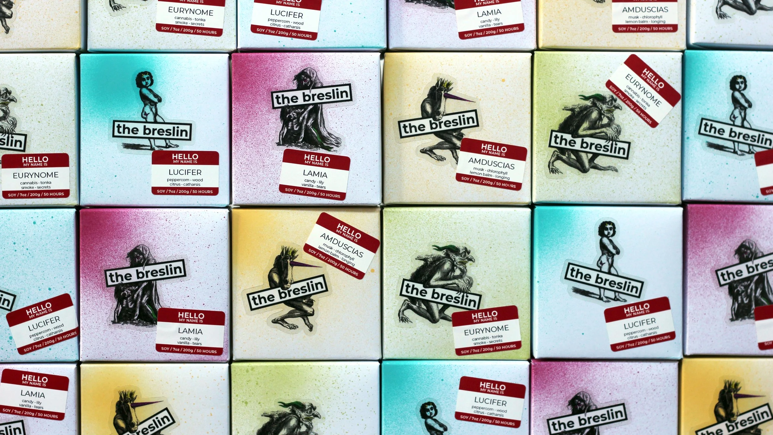 Arranged colorful boxes and packages with illustrations and labels, featuring various mythical creature branding and names like "the breslin" and "hello my name is" tags.