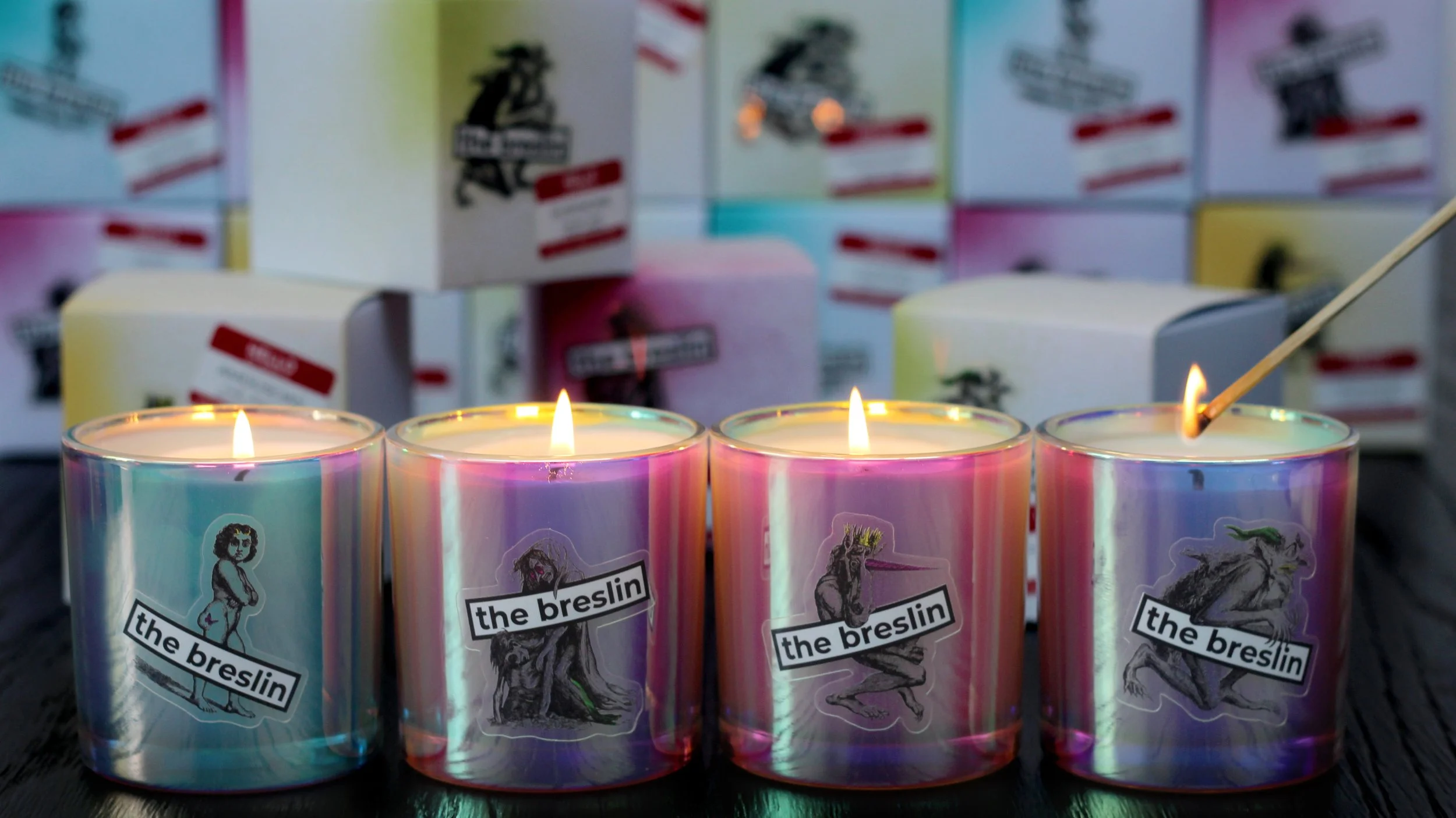 Four rainbow-colored candles with