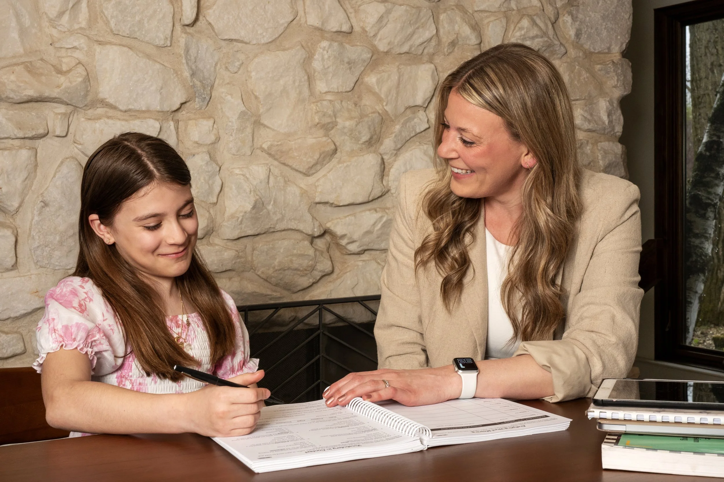 Speech therapy session with a student and clinician working together at a table using structured language materials.