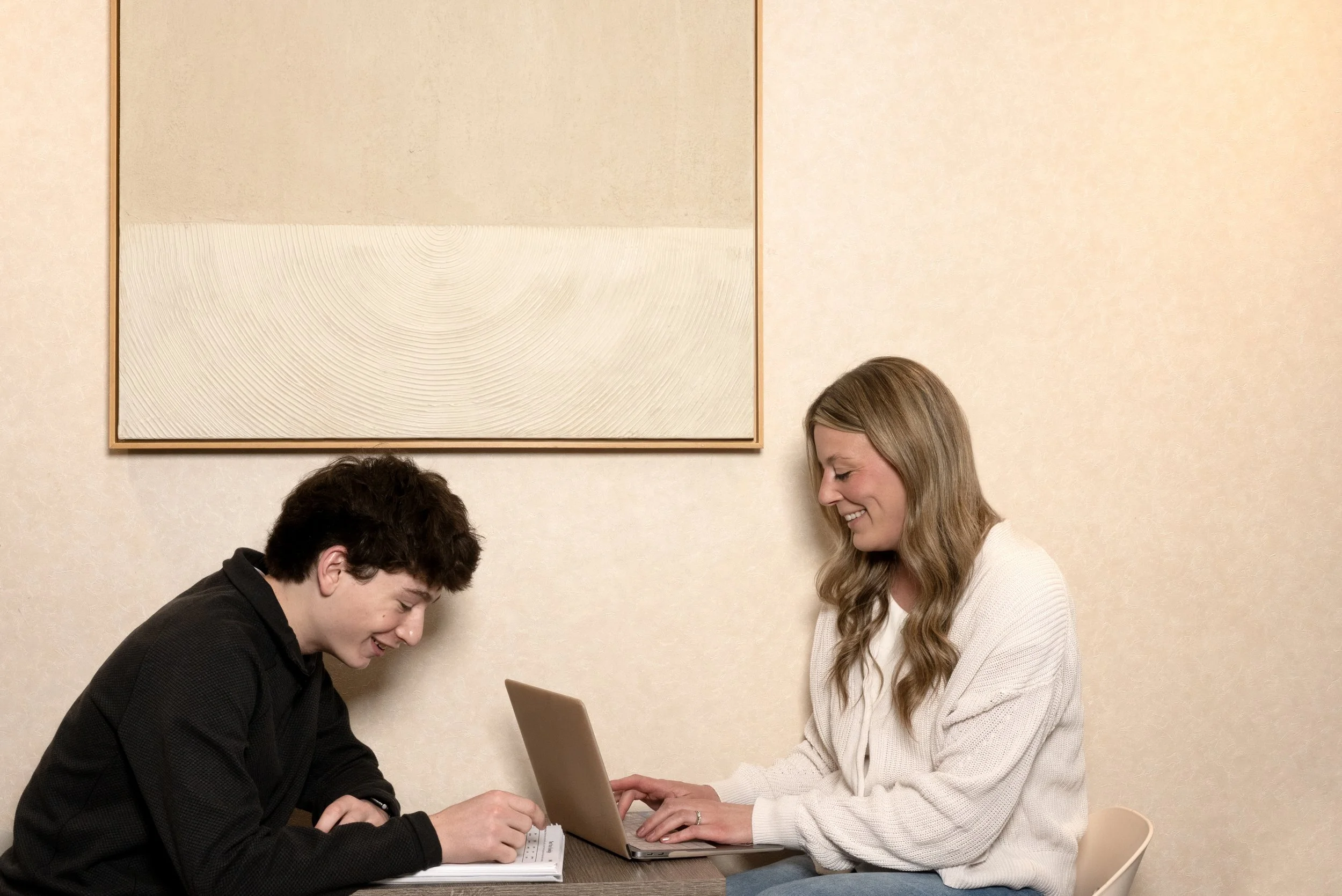 Speech therapy session with a student and clinician working together at a table using structured language materials.