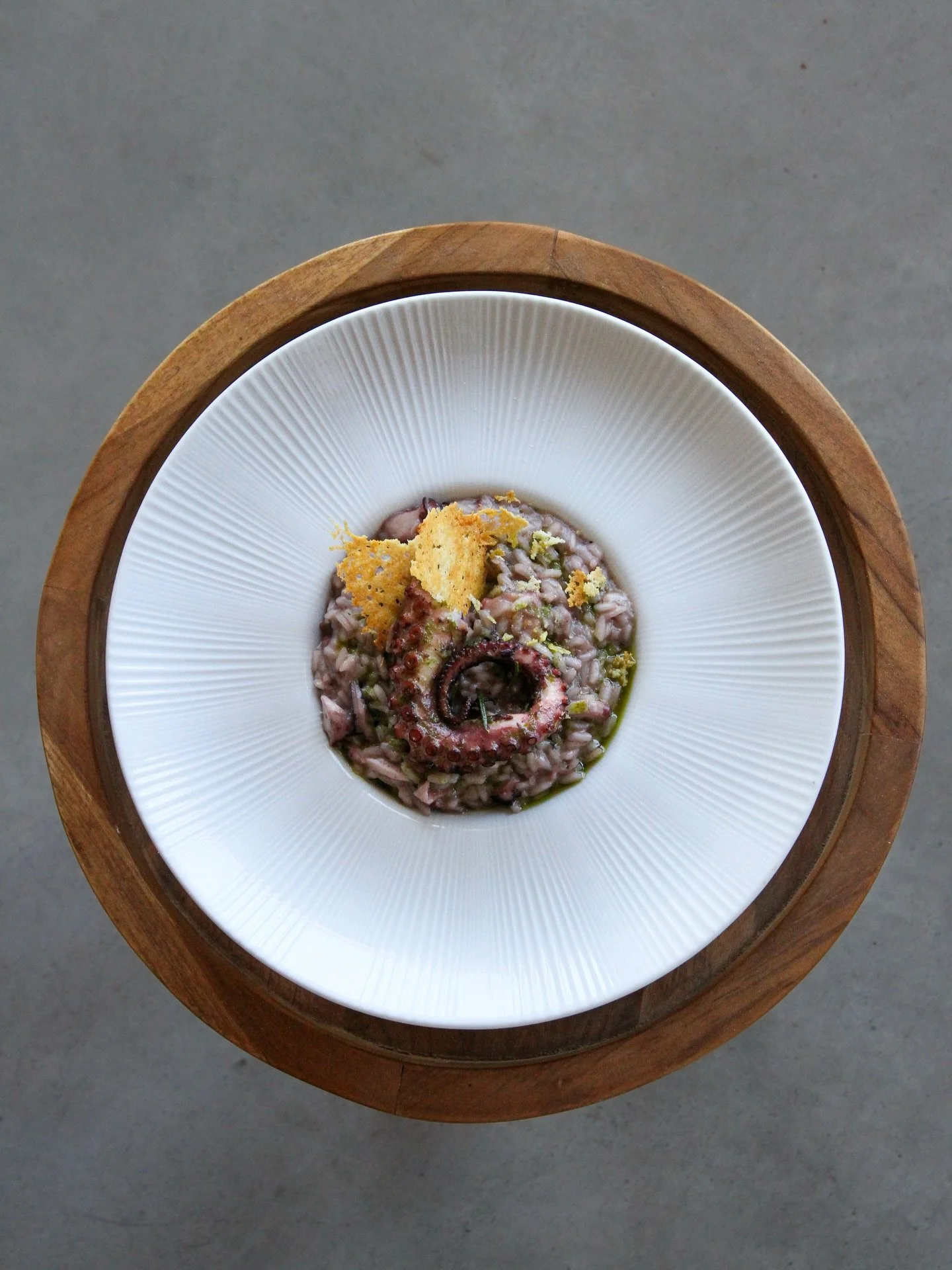 A dish guaranteed to captivate true seafood connoisseurs &ndash; our risotto Polpo in Chianti. Made with aged Acquerello rice and Atlantic coast octopus, slowly confit in rosemary and red wine, infusing every grain with vinous richness and subtle bri
