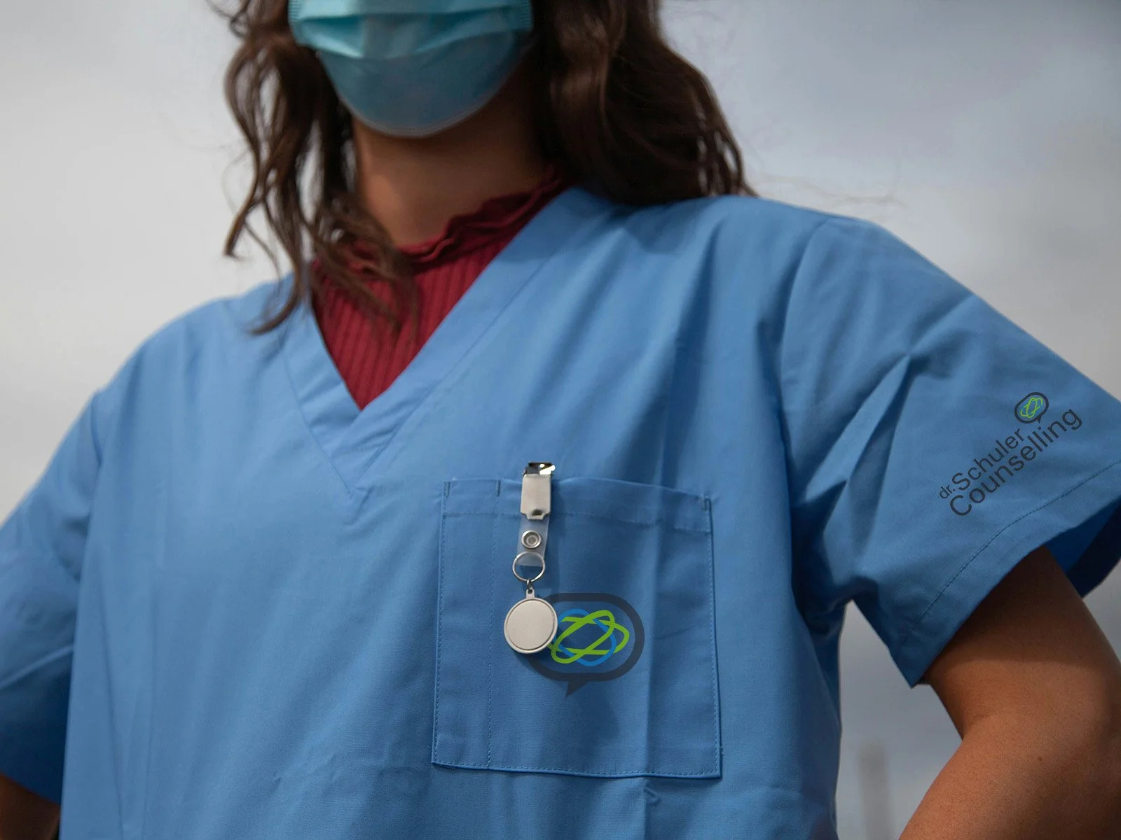 Photo of a medical practitioner wearing branded scrubs for Dr. Schuler Counselling