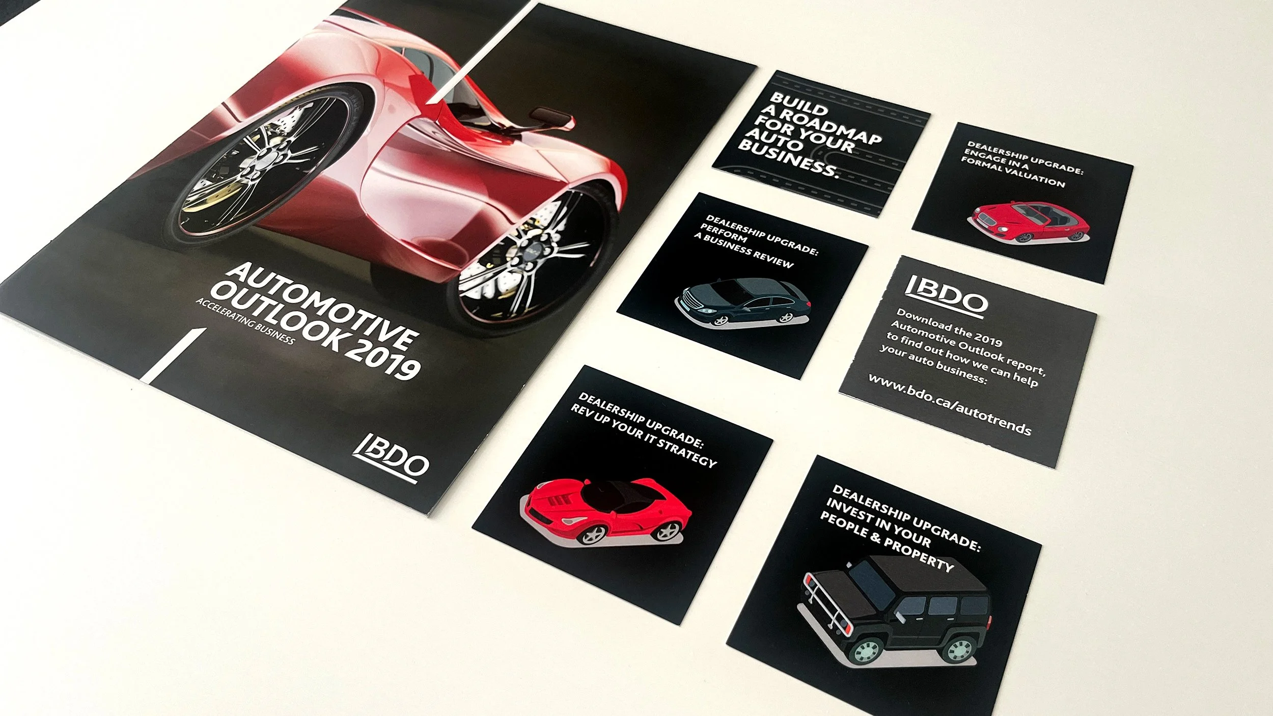 Angled photograph of the Automotive Outlook 2019 brochure with promotional card items for the Toronto Auto Show