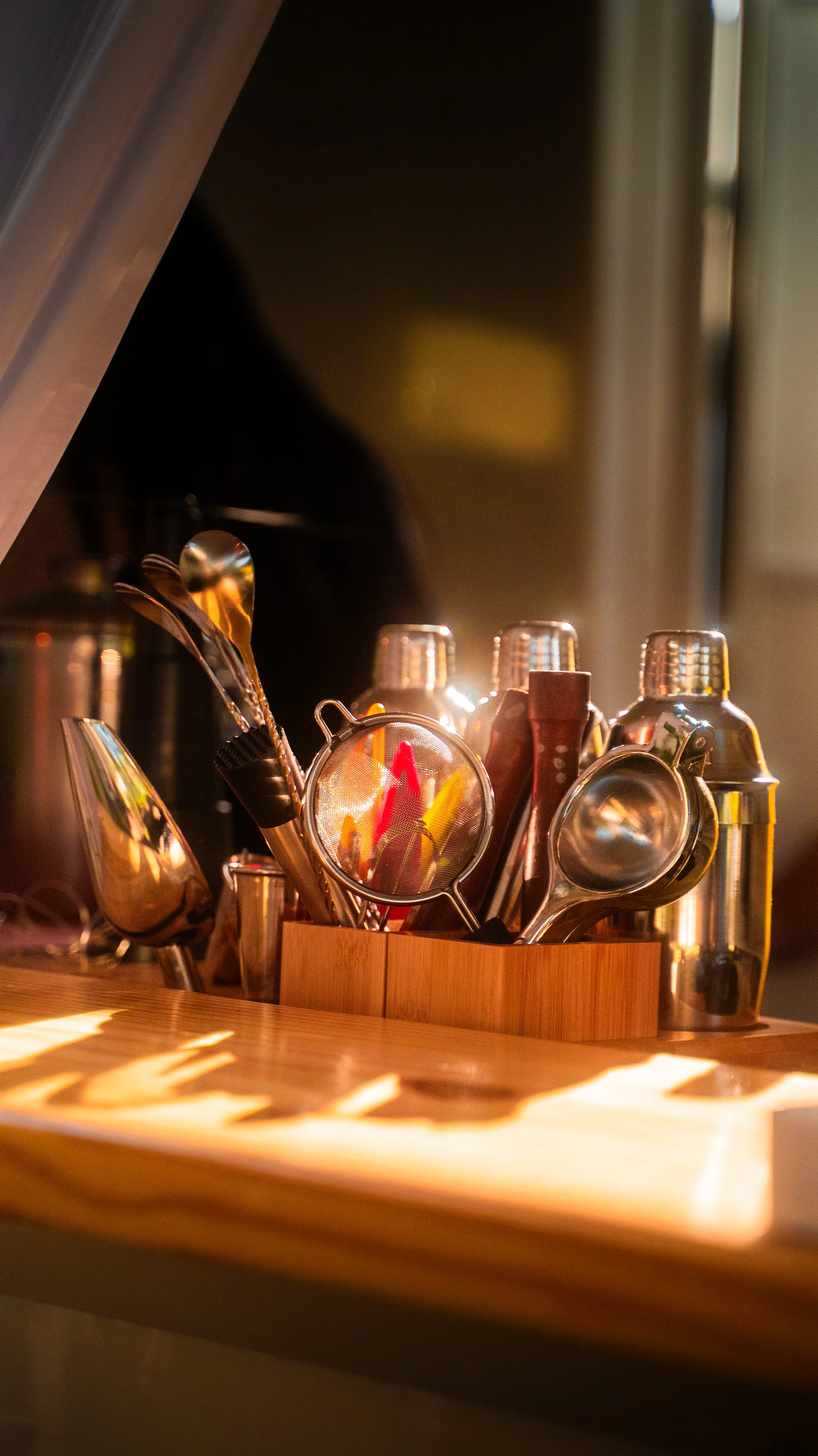 An elegant display of bar tools on the service counter of Lumière Bubble Co.'s luxury mobile bar for an engagement party celebration in Dallas.