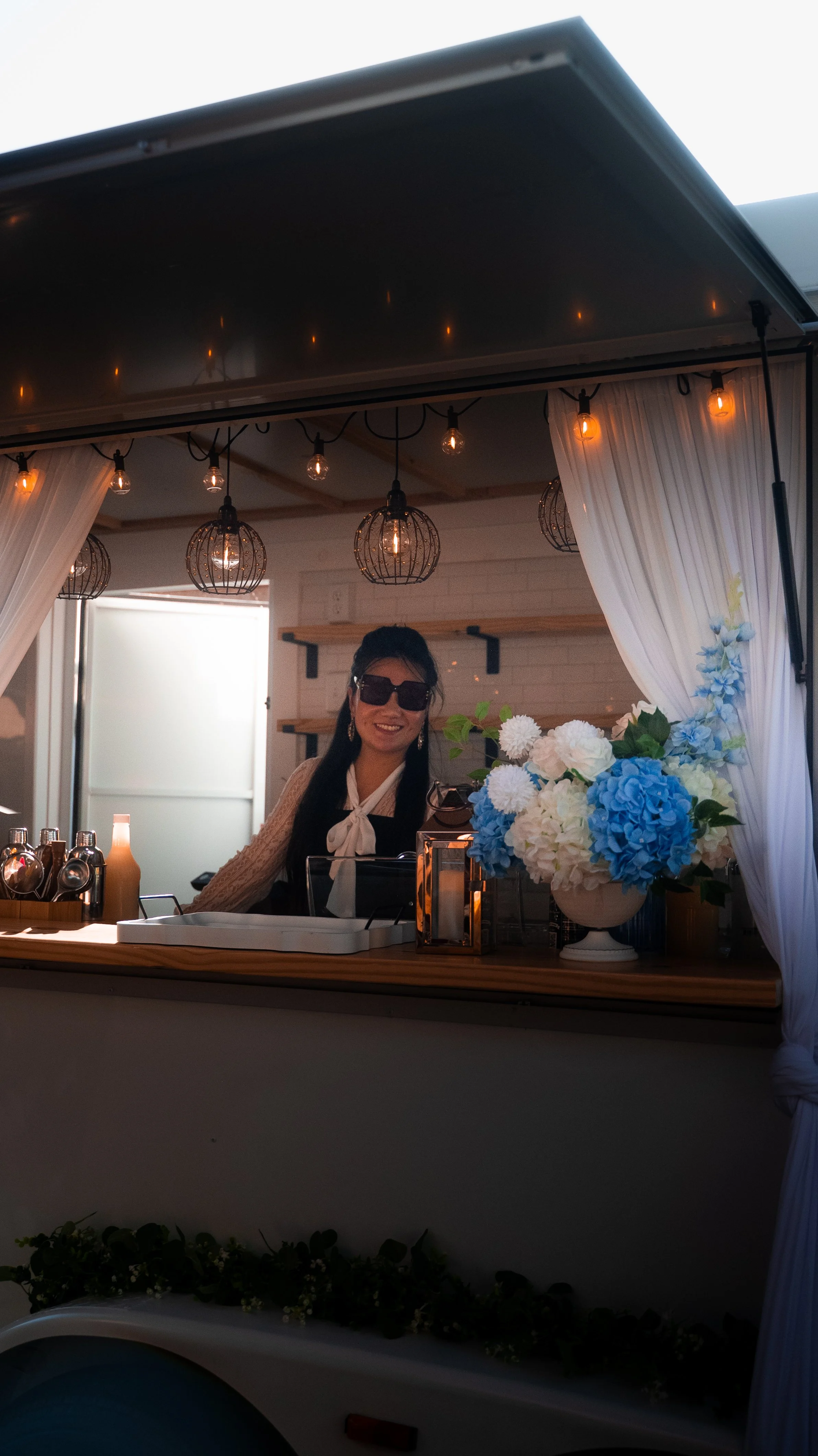 Lumière Bubble Co.'s owner posing in the trailer bar during a private engagement party celebration in Dallas.