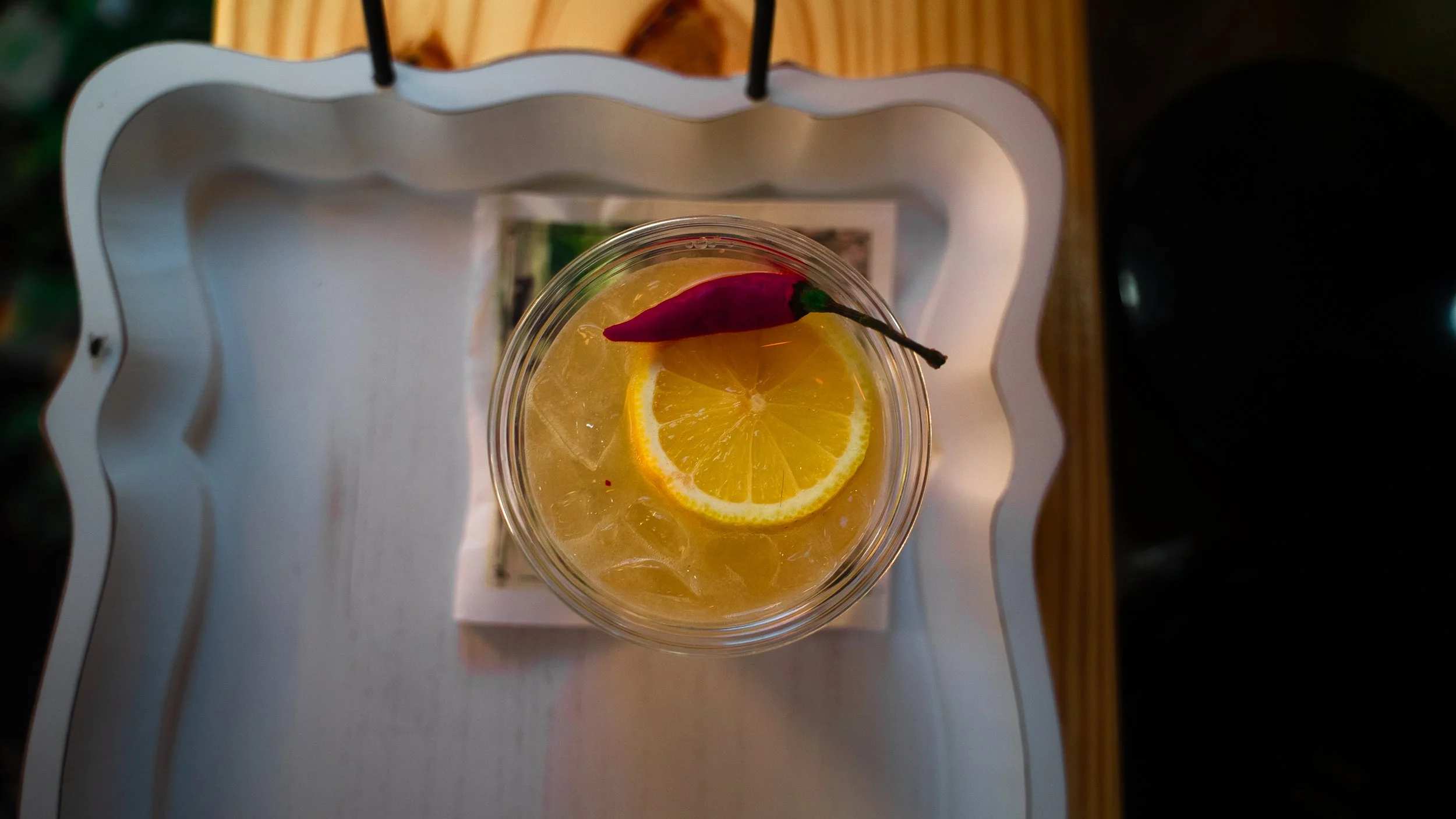 A spicy gin signature cocktail crafted for an engagement party by Lumière Bubble Co., a luxury mobile bar serving weddings, corporate events, and private celebrations in DFW.