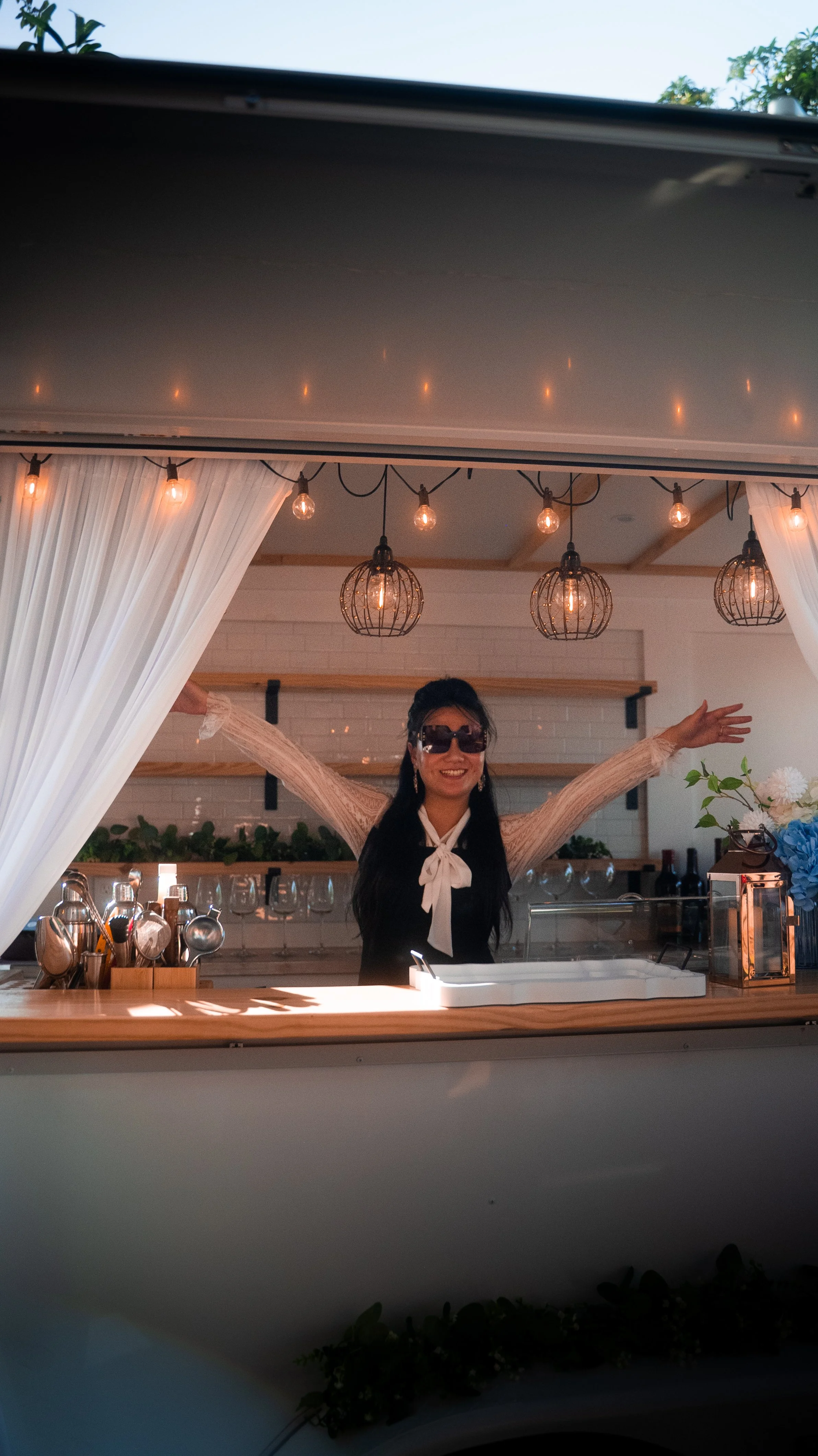Lumière Bubble Co. luxury mobile bar's owner smiling and greeting guests during an engagement party celebration in Dallas.