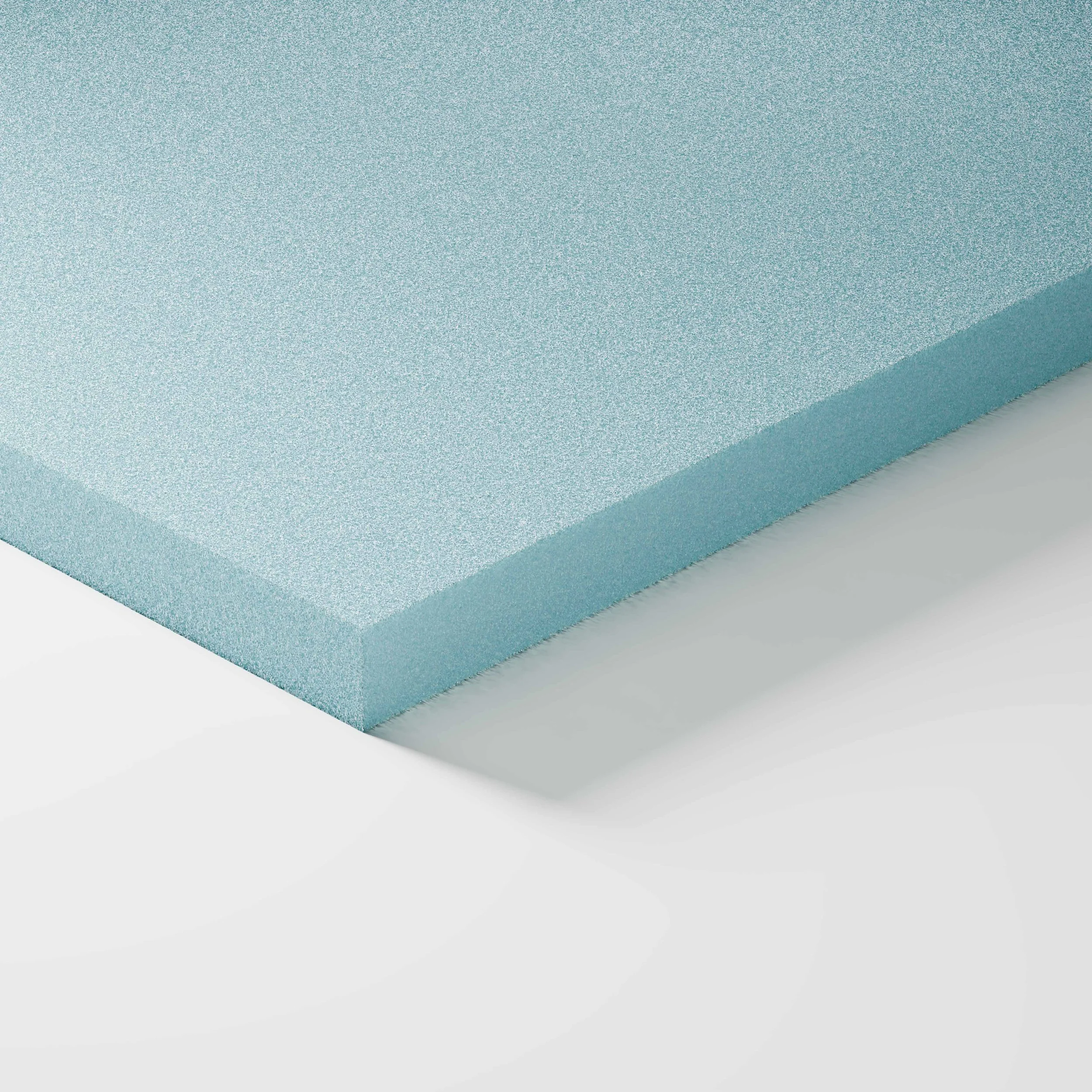 Una tavoletta di schiuma blu chiara con bordo arrotondato, su sfondo bianco.