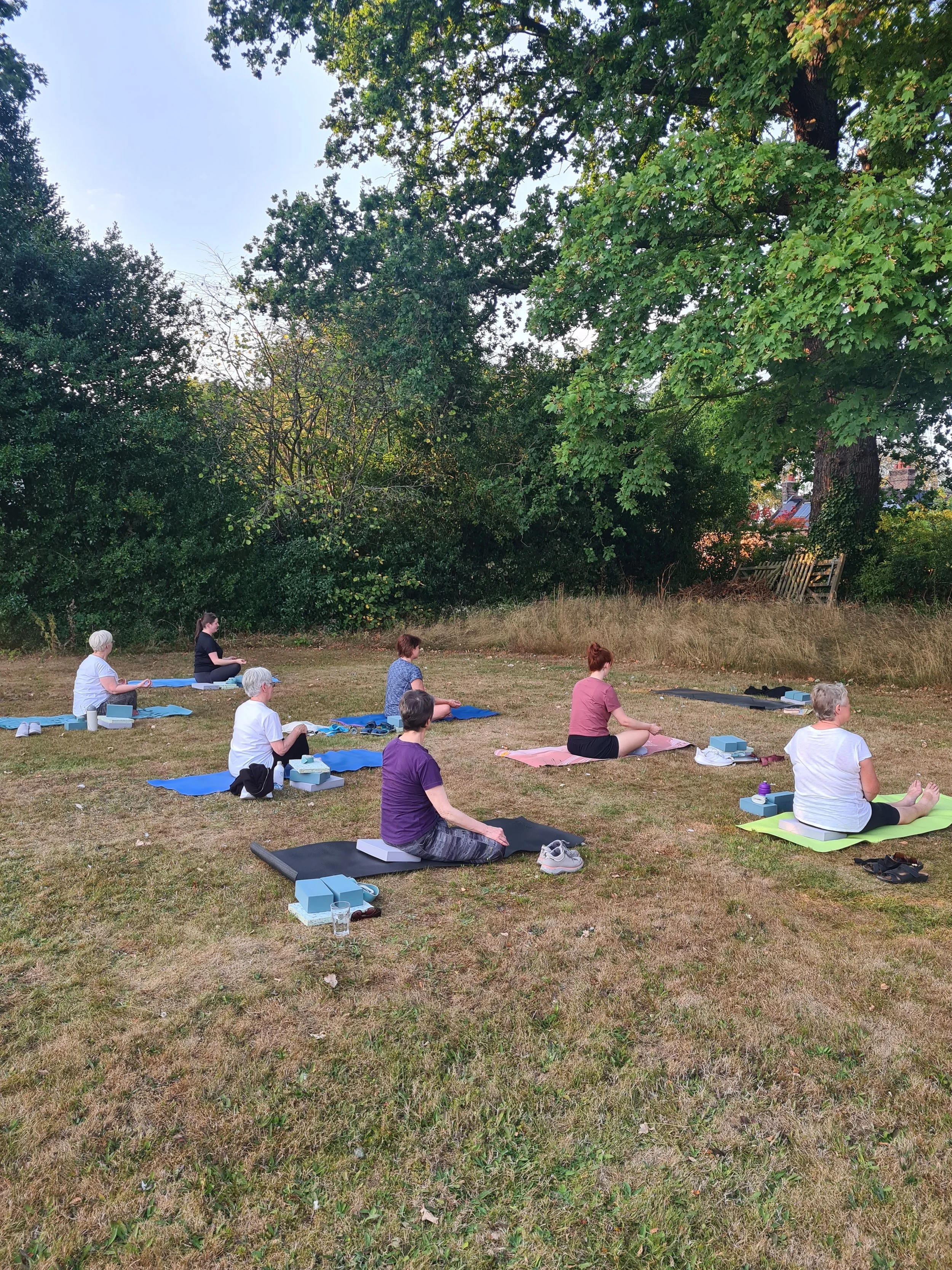 Outdoor group yoga class in Northwich, Cheshire, offering gentle movement, mindfulness and relaxation in a peaceful natural setting.