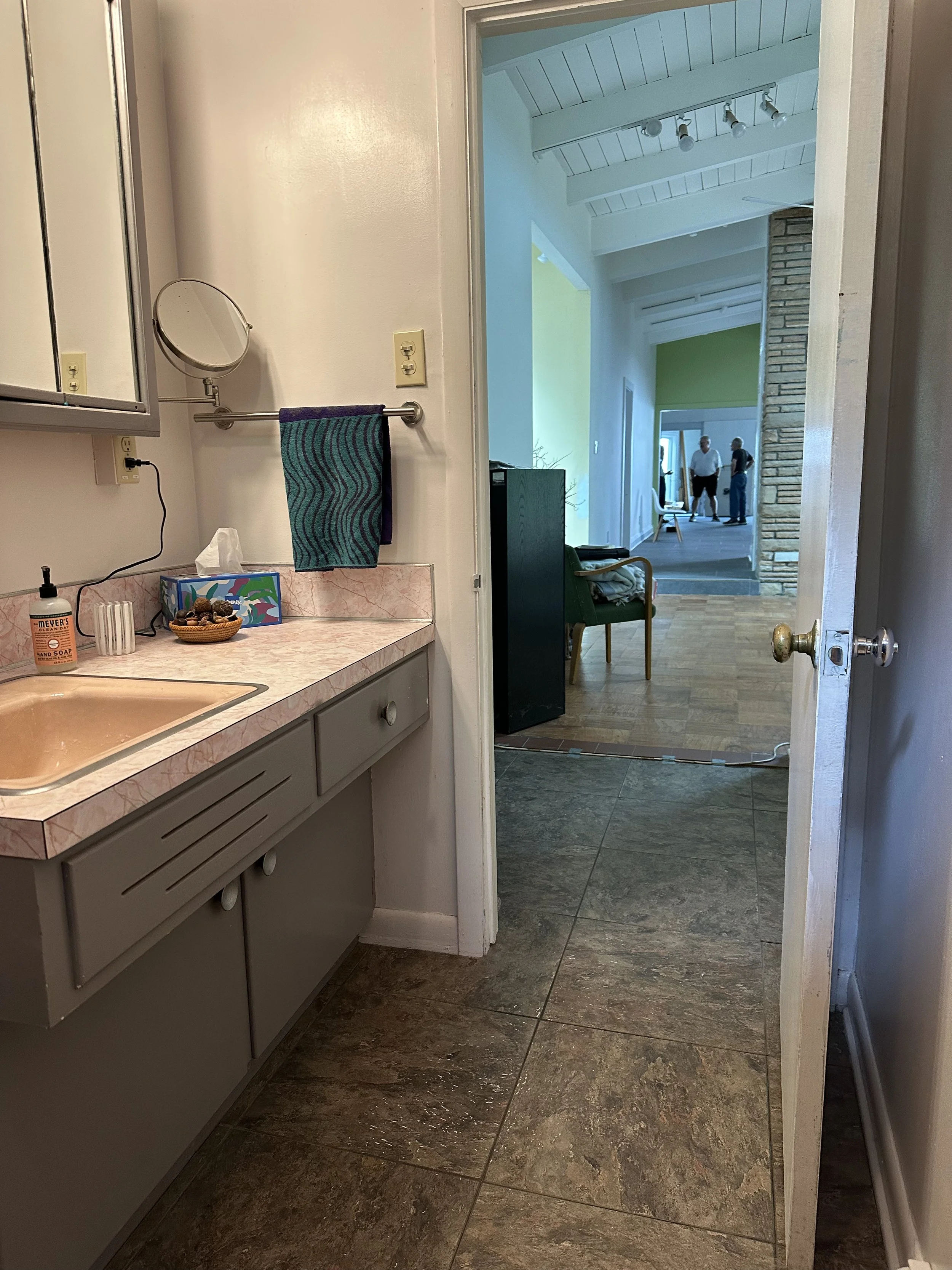 The bathroom, while functional, featured outdated finishes, mismatched fixtures, and limited visual continuity, creating a space that felt both cramped and out of sync with the rest of the home.