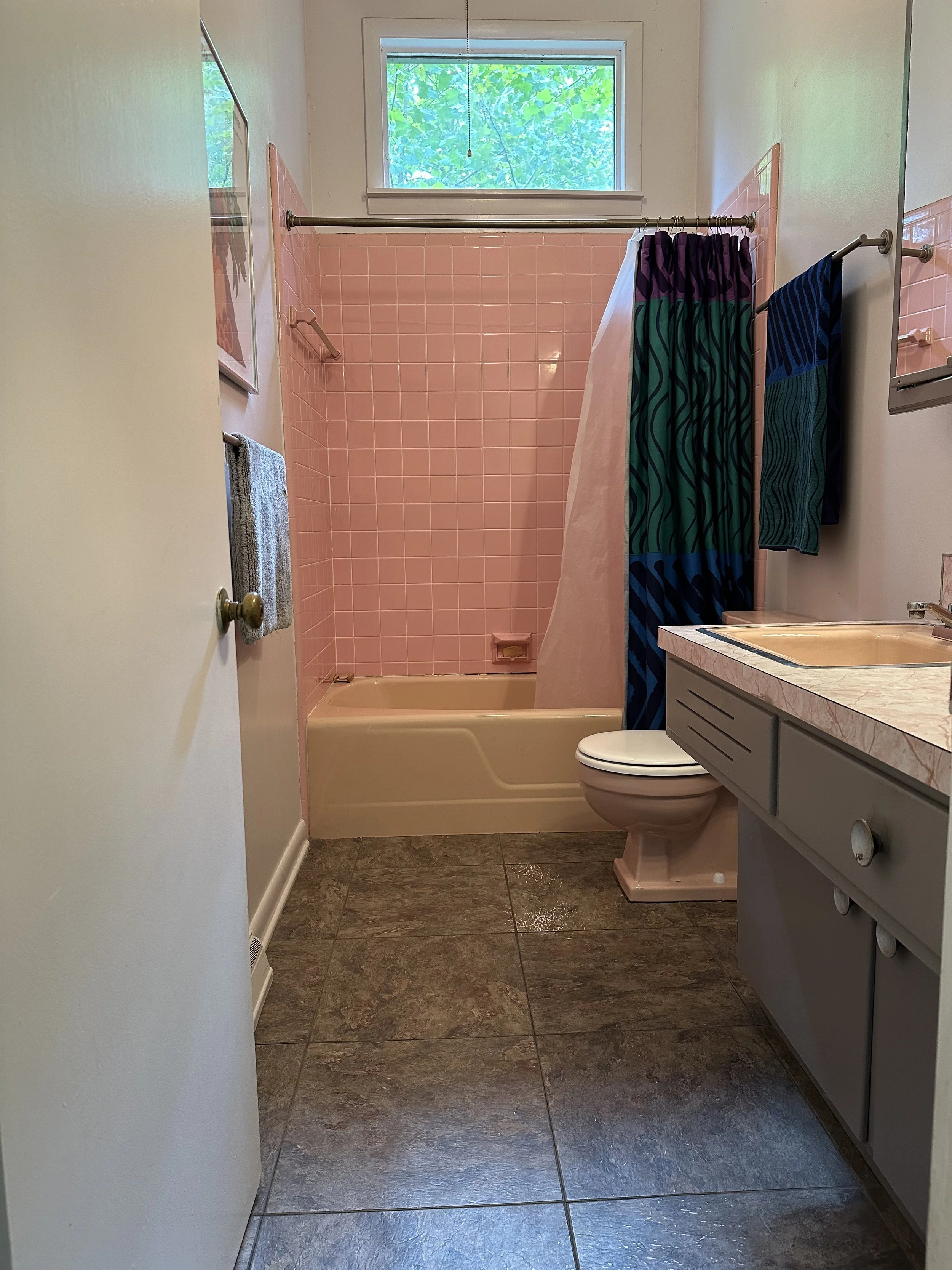 The bathroom, while functional, featured outdated finishes, mismatched fixtures, and limited visual continuity, creating a space that felt both cramped and out of sync with the rest of the home.