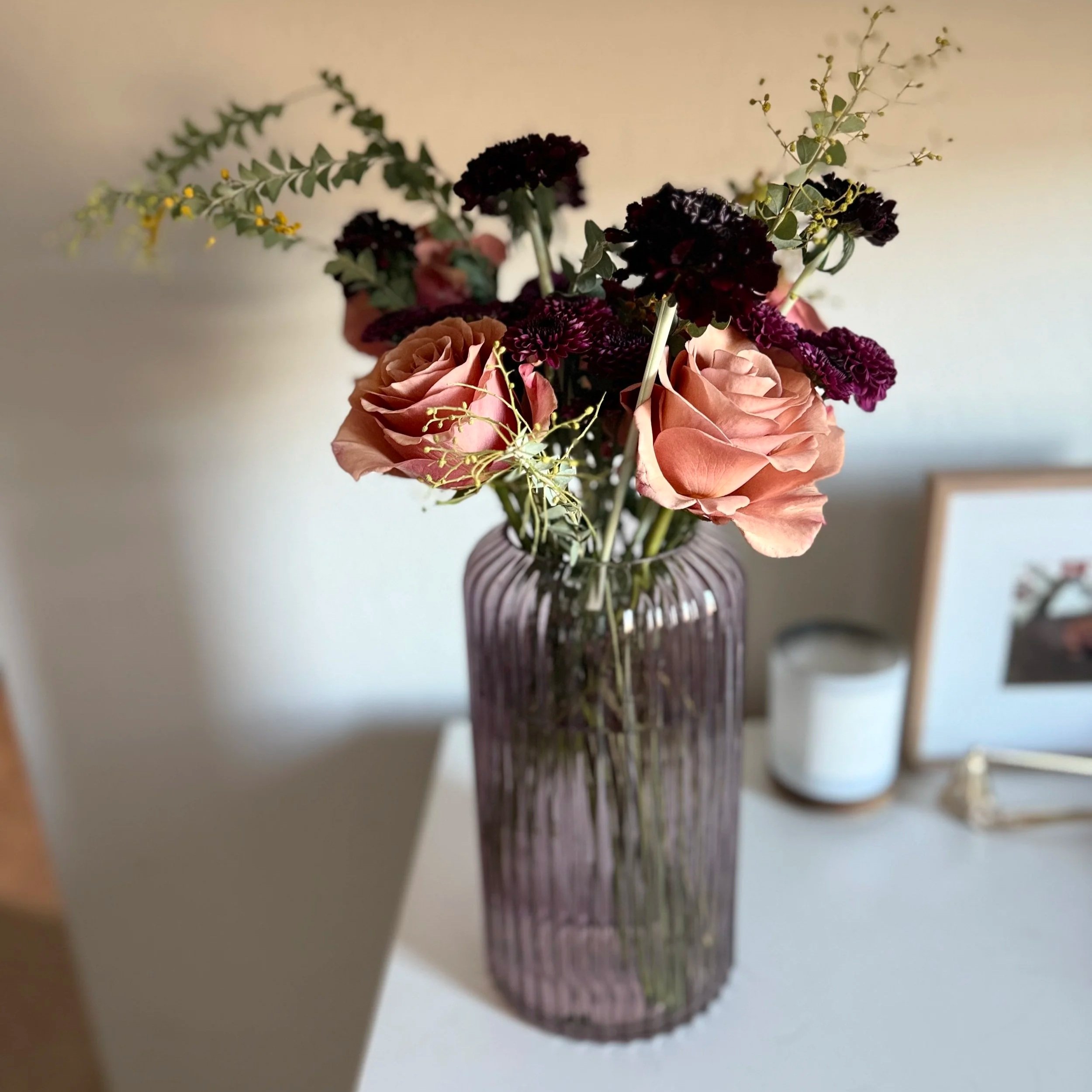 Moody Roses with Darker Purple complements. Give this arrangement depth.