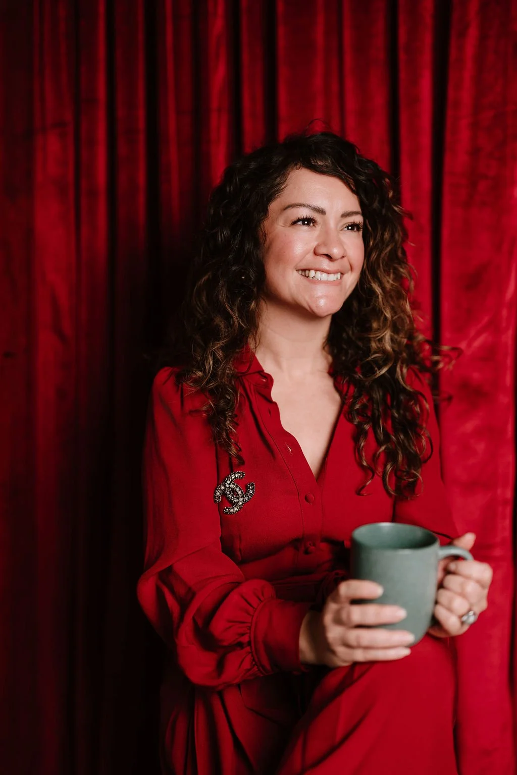 Cynthia Platero, executive coach for high-achieving creative women, holding a gray coffee mug.