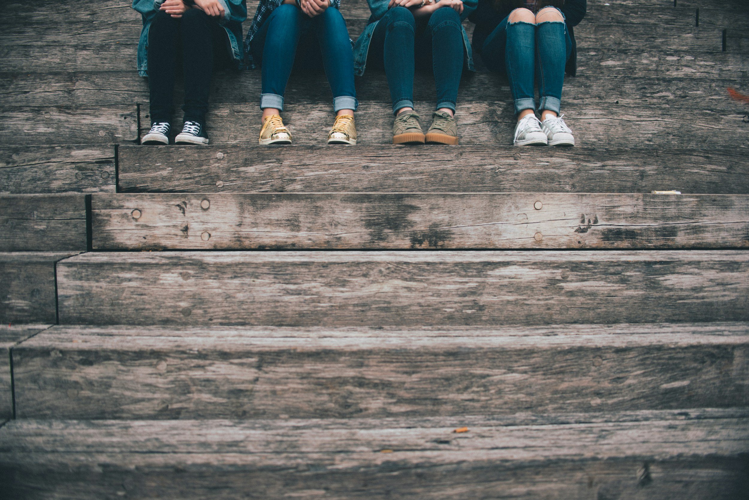 Group of young people sitting together outdoors — representing belonging and youth counselling in Illawong.