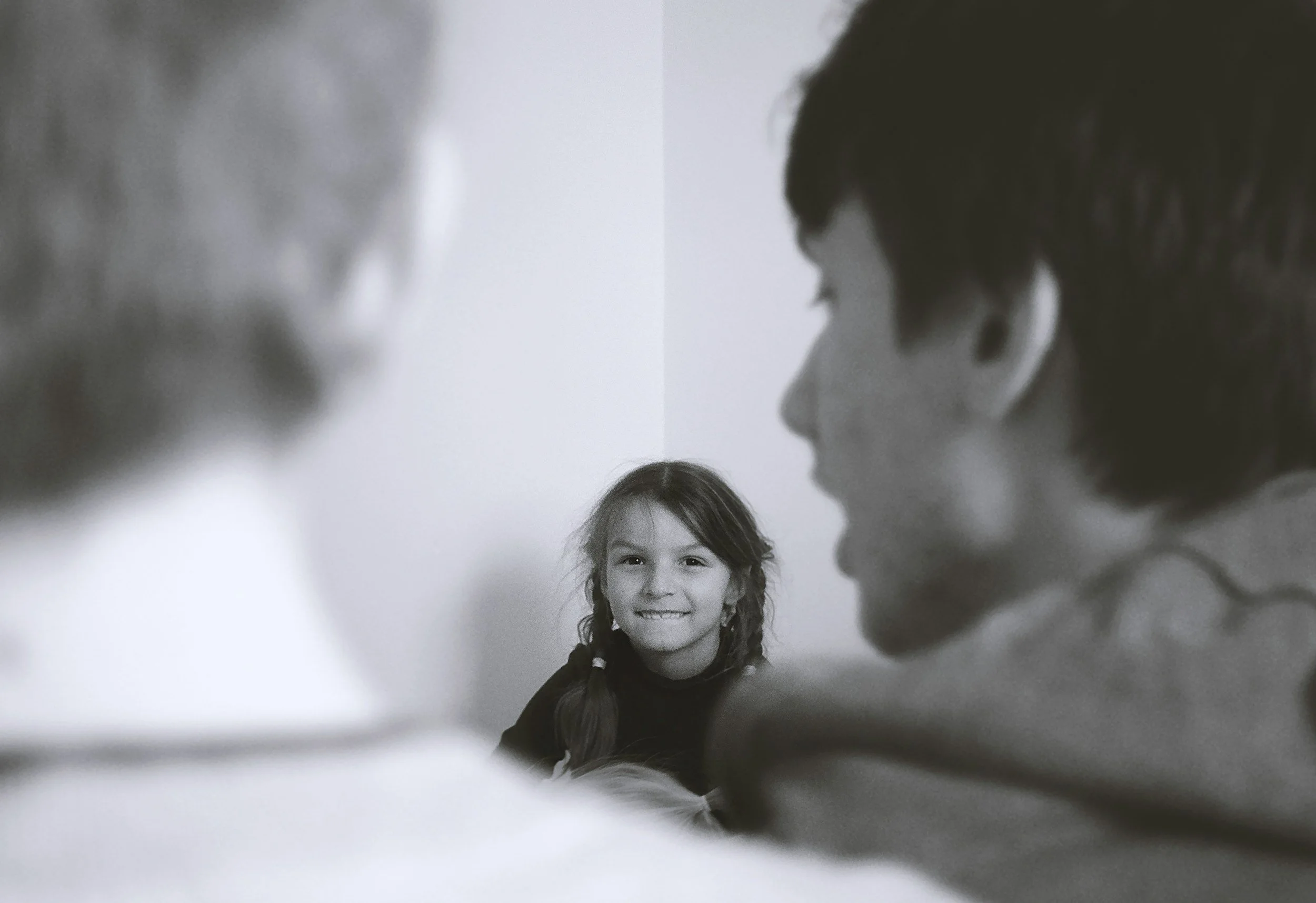 Child receiving emotional support from parents during counselling or anxiety support discussion