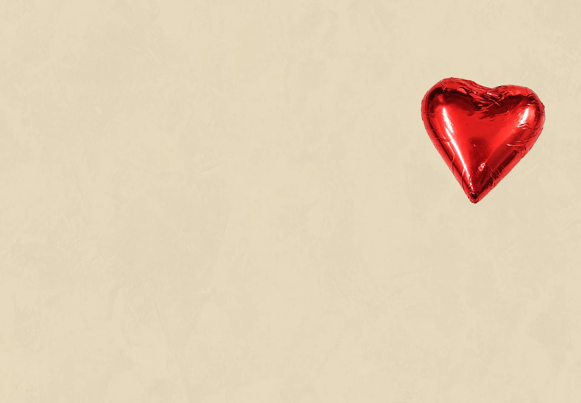 Cream background with red chocolate heart