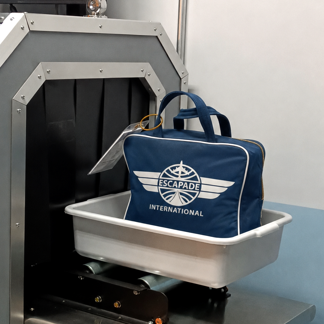 Escapade International travel bag being scanned in the prop scanner at Urban Escapade escape room, Sydney