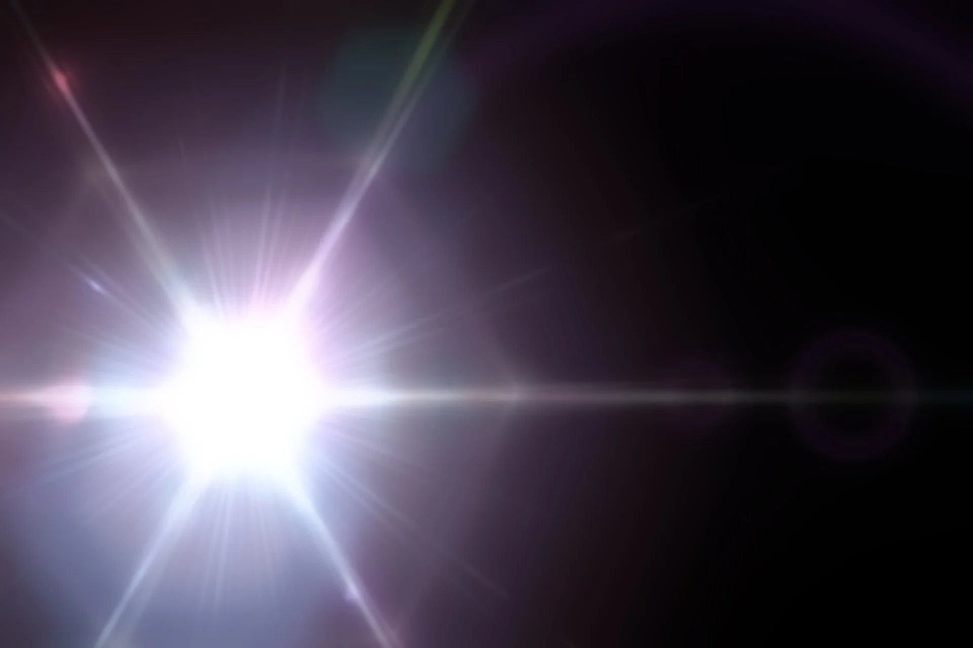 Bright light on a black background causing glare.