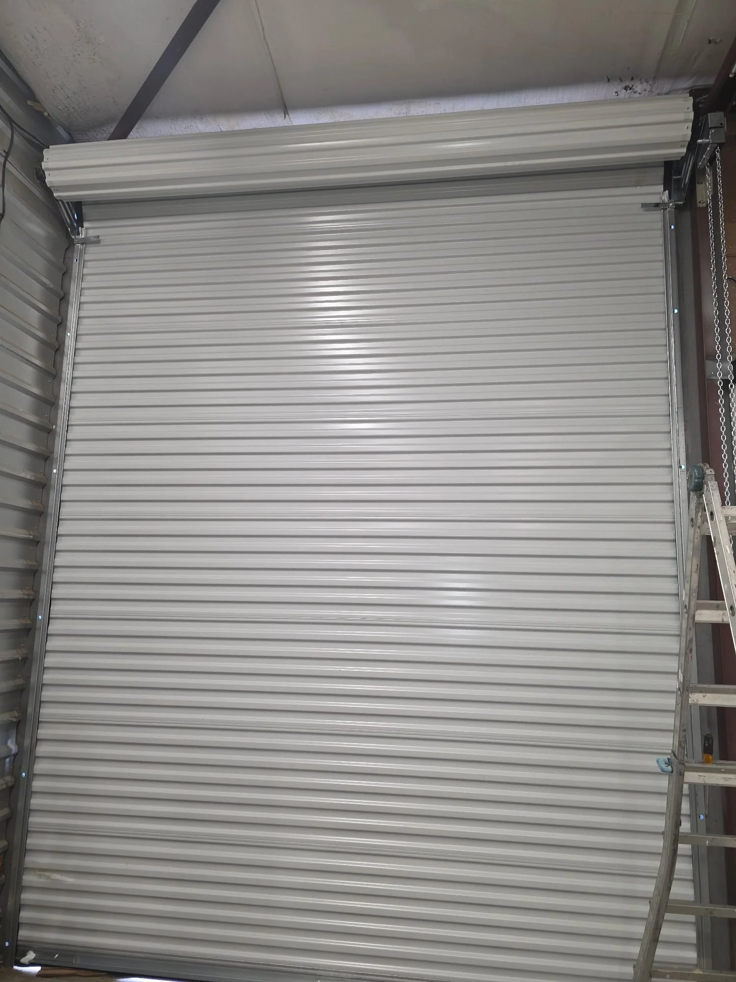 New white commercial roll-up door after installation