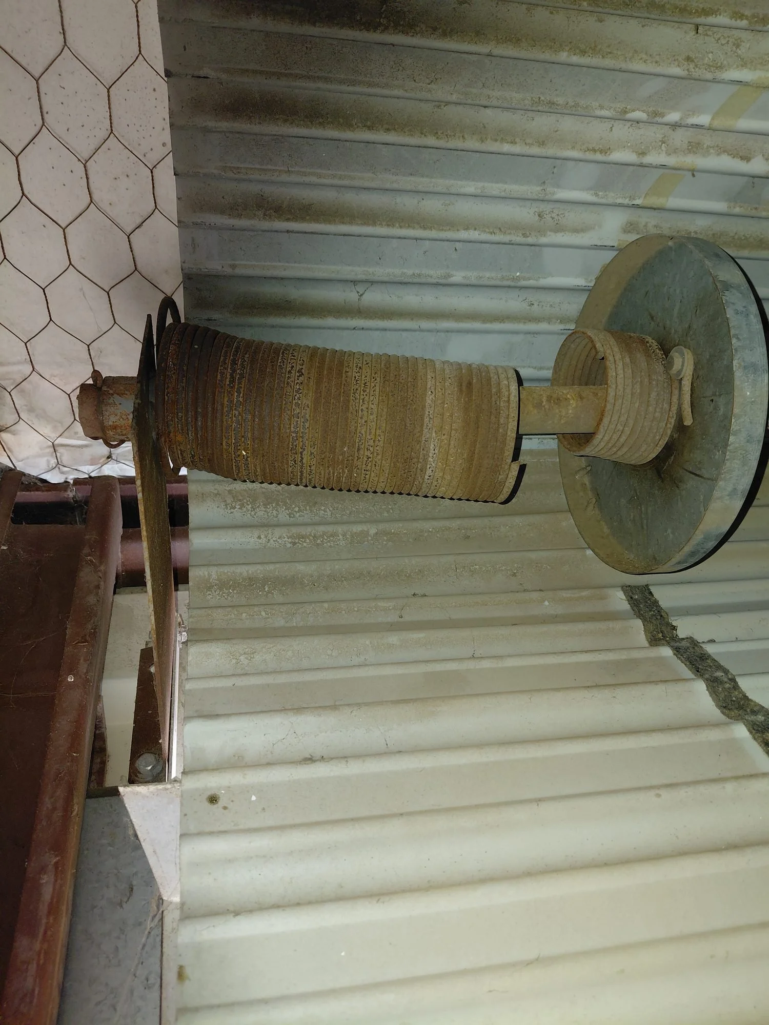 Garage door torsion spring and drum being replaced in Arlington, TX