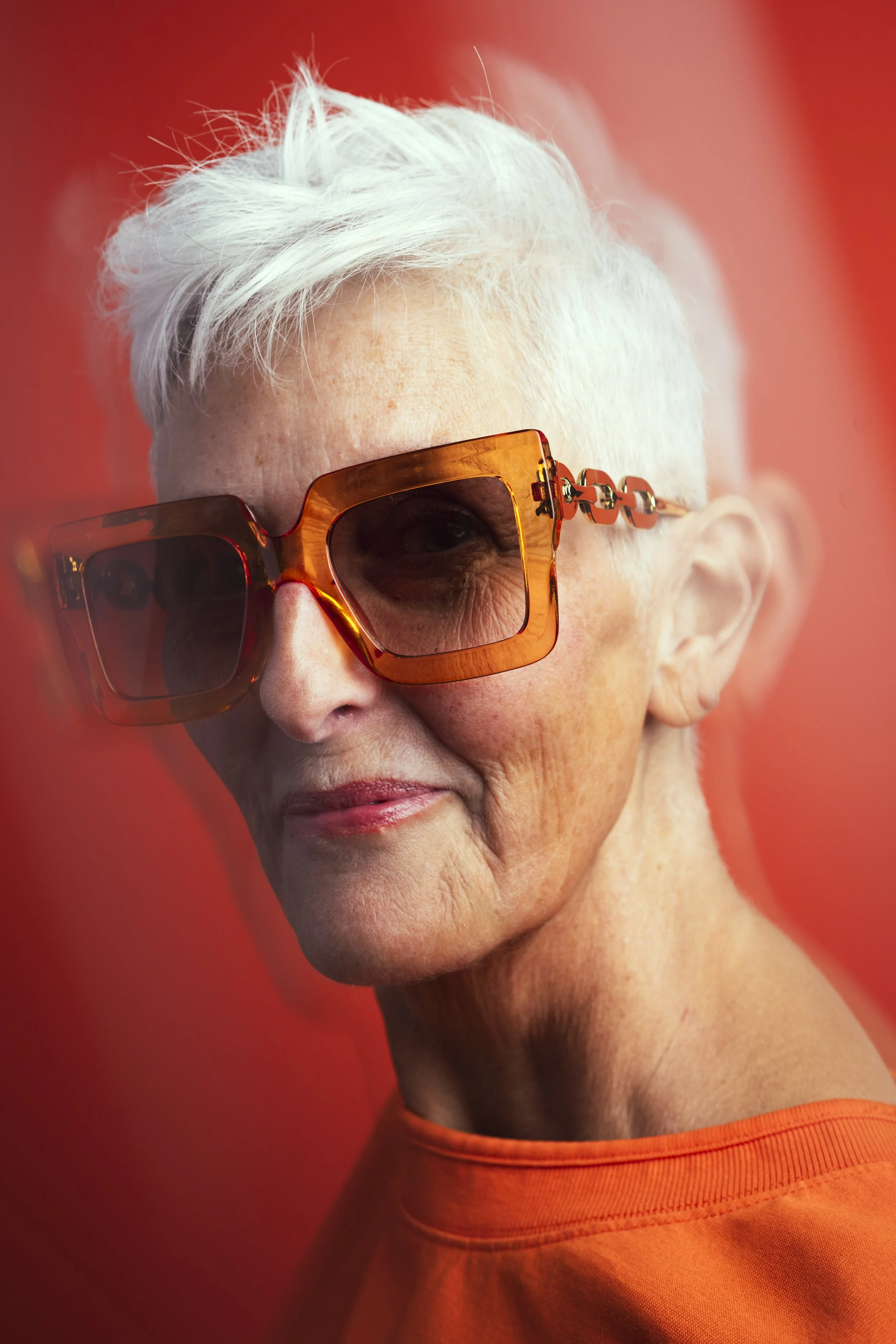 Headshot of a Woman on an orange backdrop