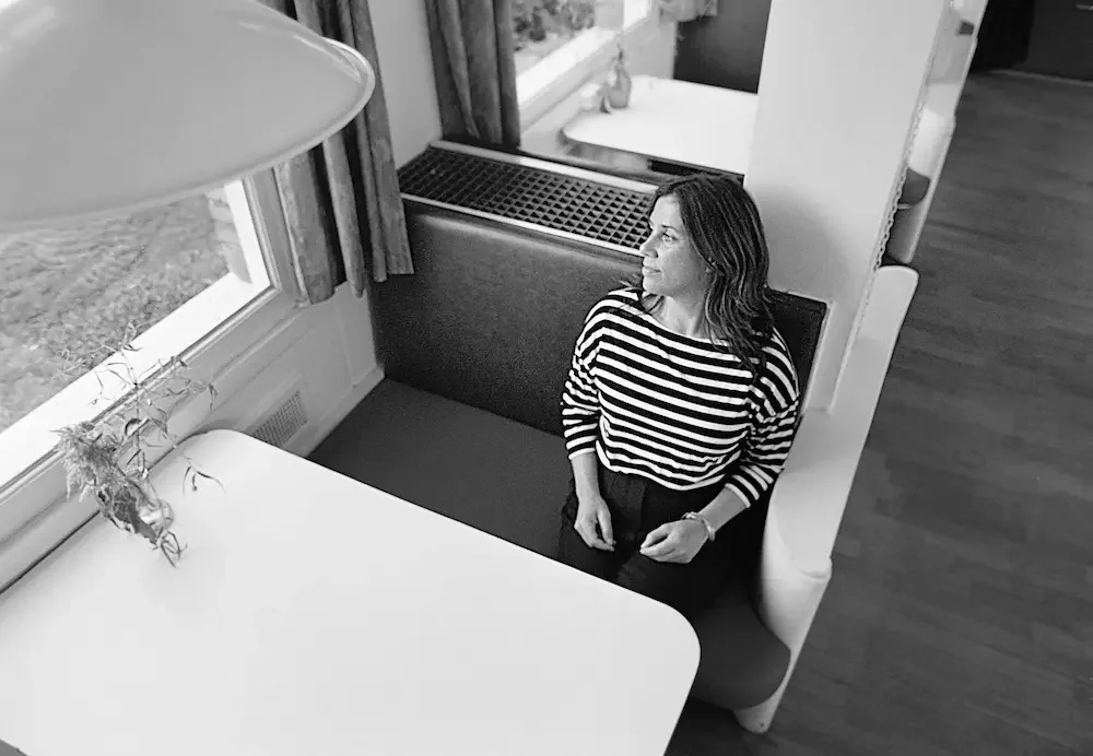 Rinske Englander, Gestalt therapist in Amsterdam, seated by a window in a reflective moment