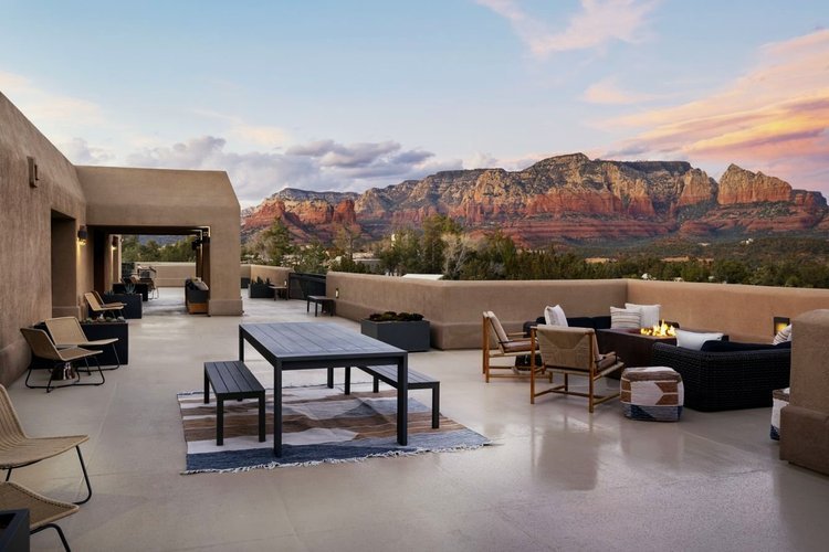 Open terrace with outdoor seating and Sedona's mountain view at sunset.