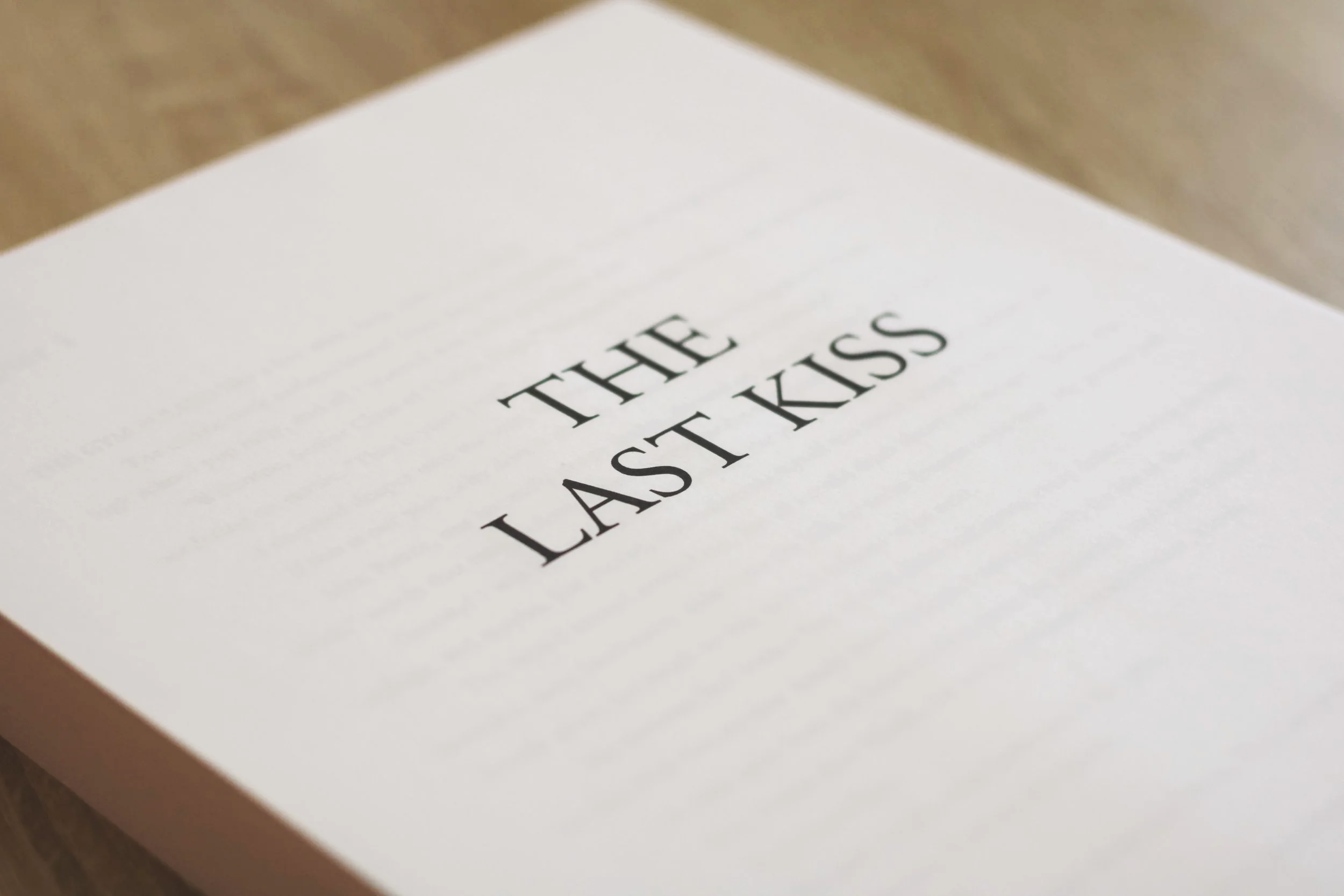 Close-up of a white envelope with 'THE LAST KISS' written on it in bold black letters.