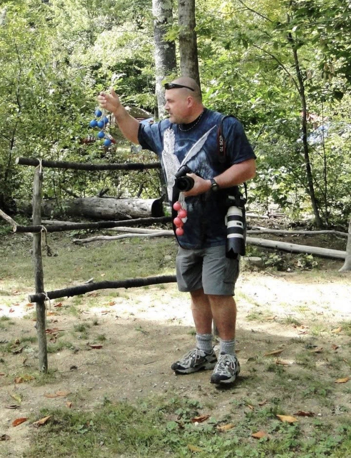 Person holding a throwing object beside an outdoor game frame.