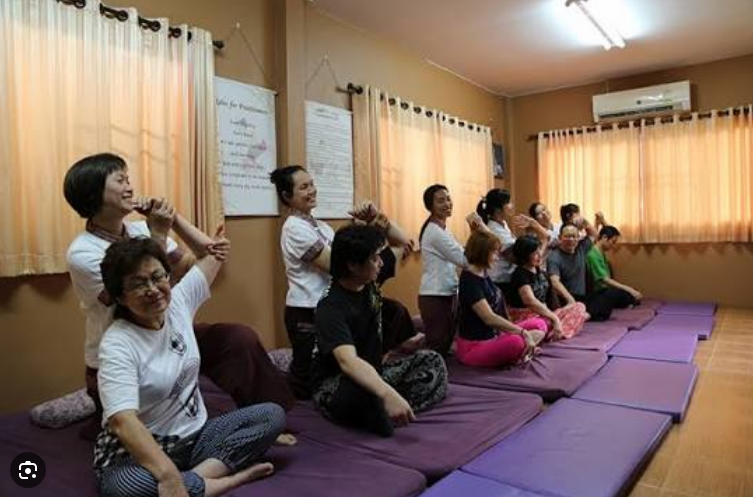Students learning traditional Thai massage