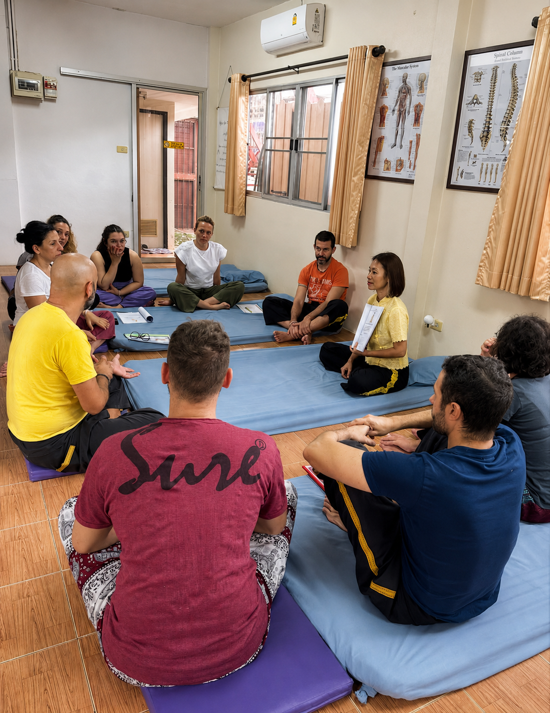 Students learning traditional Thai massage at Ong Thai Massage School in Chiang Mai