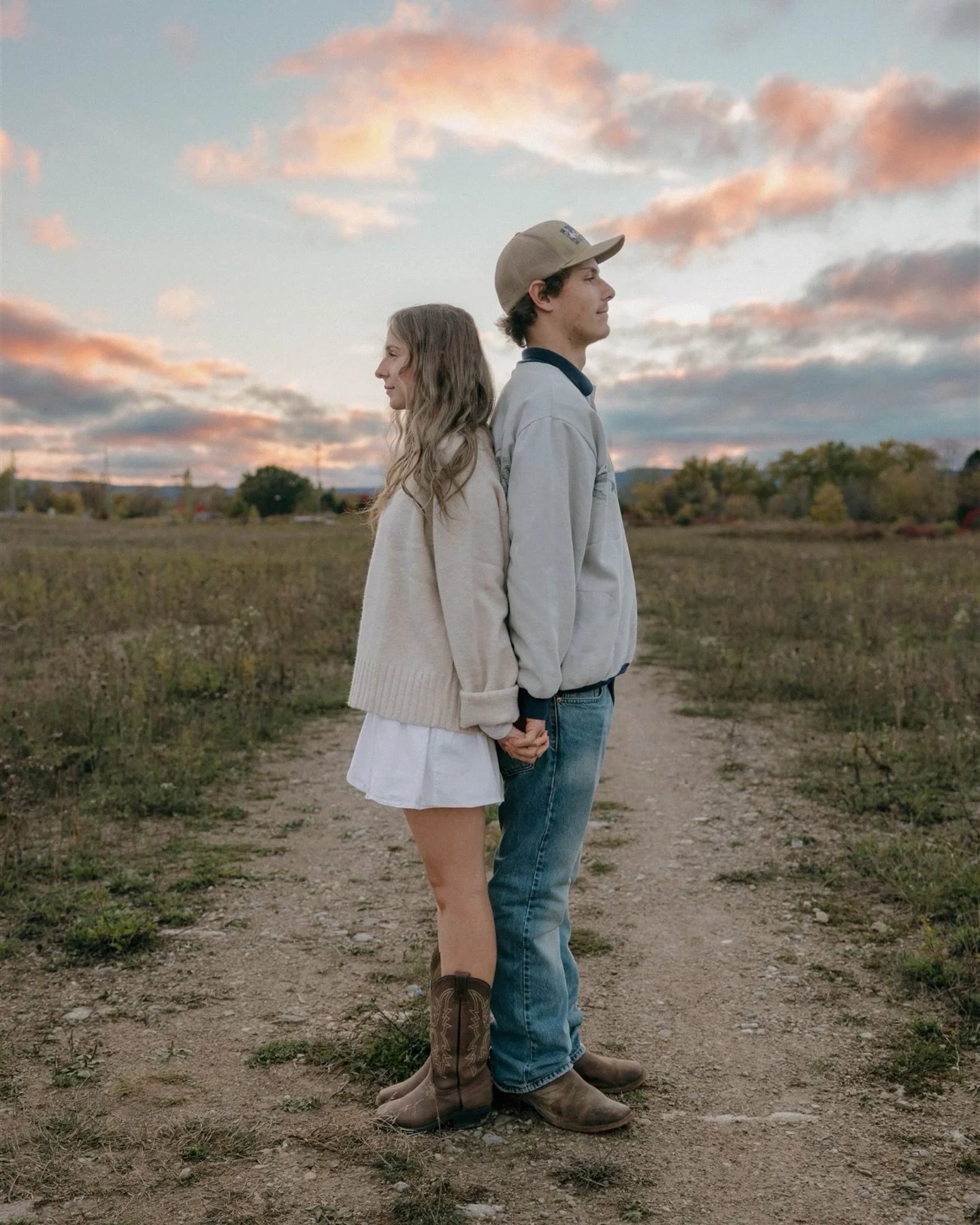 A photoshoot is found in the in-between moments. 

Cowboy boots in the grass, a field stretching wide, a pink and blue sky fading into orange as the sun settled slow behind them.

The quiet laughs.
The almost-kisses.
The way they looked at each other