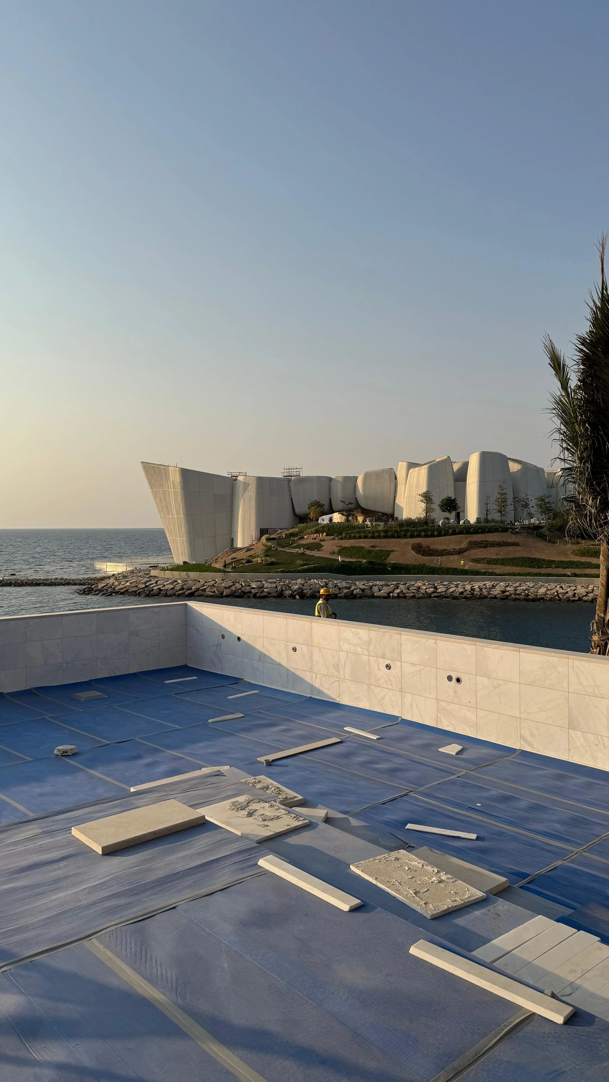 Workers using a road paving machine to lay asphalt on a road.