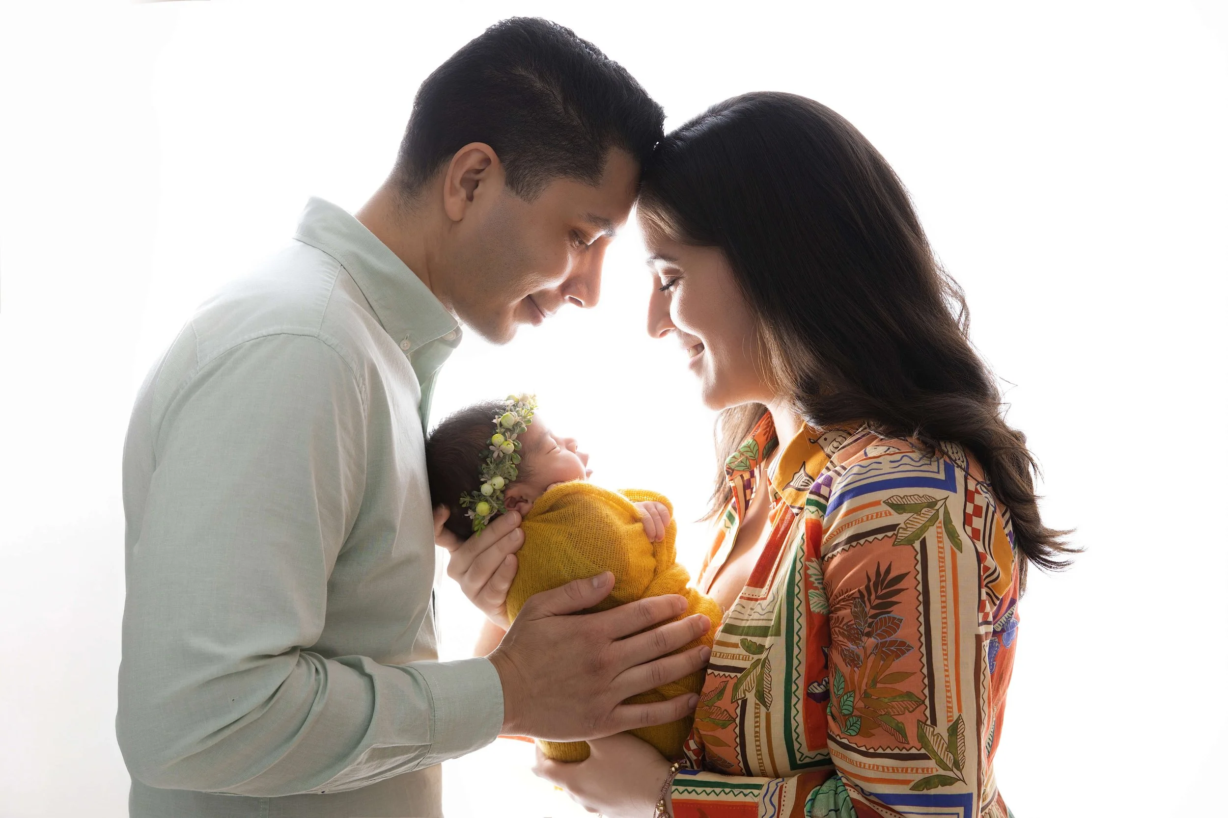 Family photos of mom, dad, and newborn baby in Gentle Glances family studio in Allen, TX