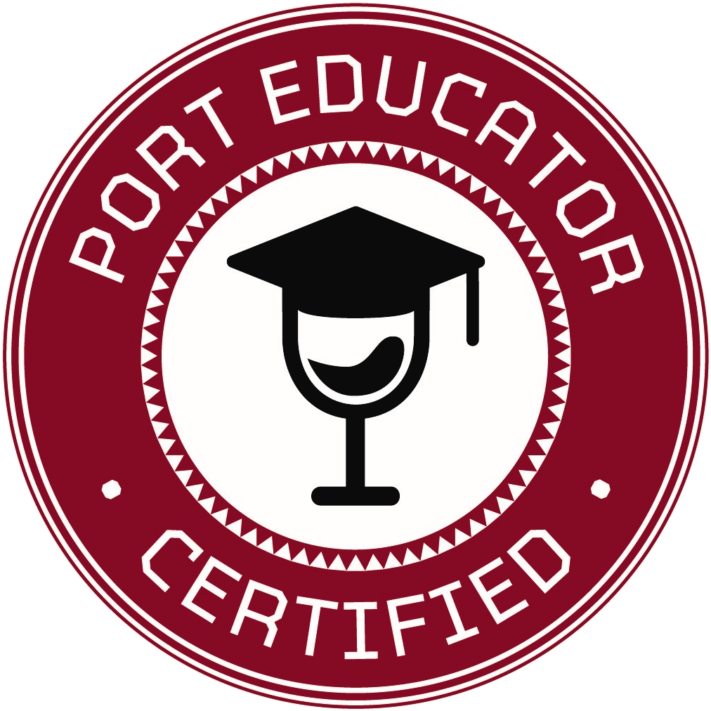 A circular badge with a maroon border and white background. Inside, there is a black graduation cap on top of a wine glass. The text reads "Port Educator Certified" around the border.