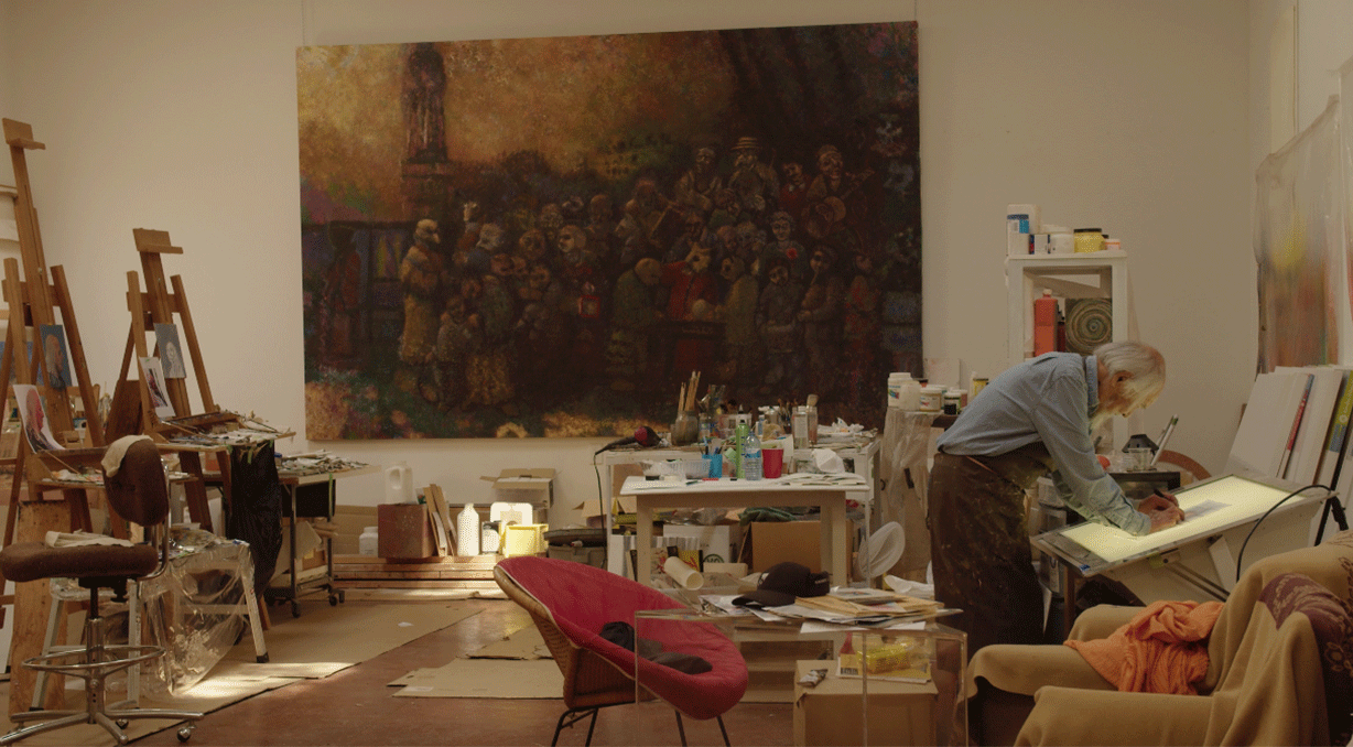 Harry Kiyooka's studio: Harry Kiyooka working at a lightbox, surrounded by his paintings, art supplies, and artworks in progress.