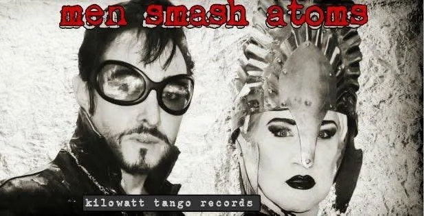 A black and white photo featuring a man with dark sunglasses and a pendant, next to a mannequin head with a spiky hairstyle and bold makeup. Text on the image reads 'men smash atoms' in red font and 'kilowatt tango records' in smaller white text.