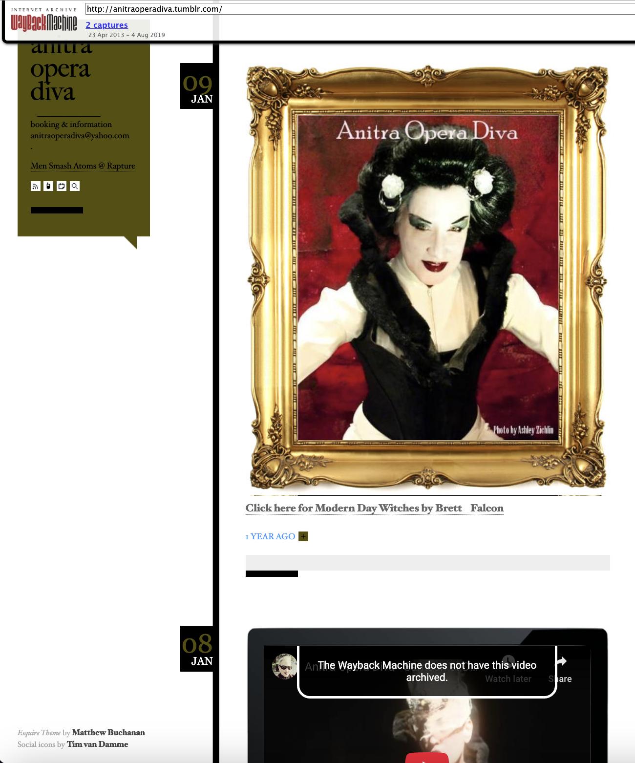 A woman with dark hair styled in an elaborate updo decorated with white flowers, wearing theatrical makeup, a white blouse, and a black corset, is shown within a gold ornate frame. The background is dark red.