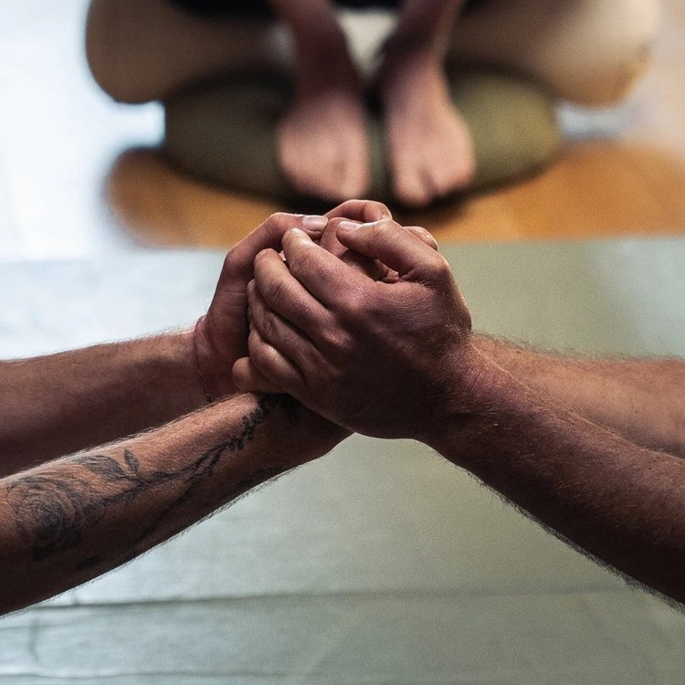 Two men clasping hands