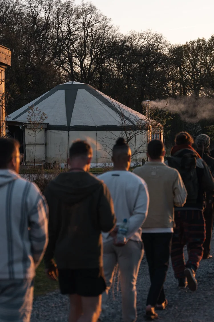 Men walking at a retreat at sunset