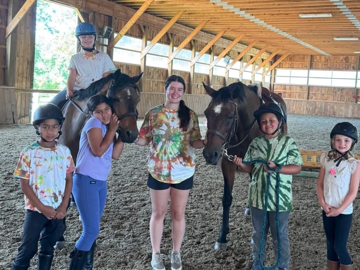 Two brown horses with camp kids at Windstar Farm, Sterling, MA Summer 2025.