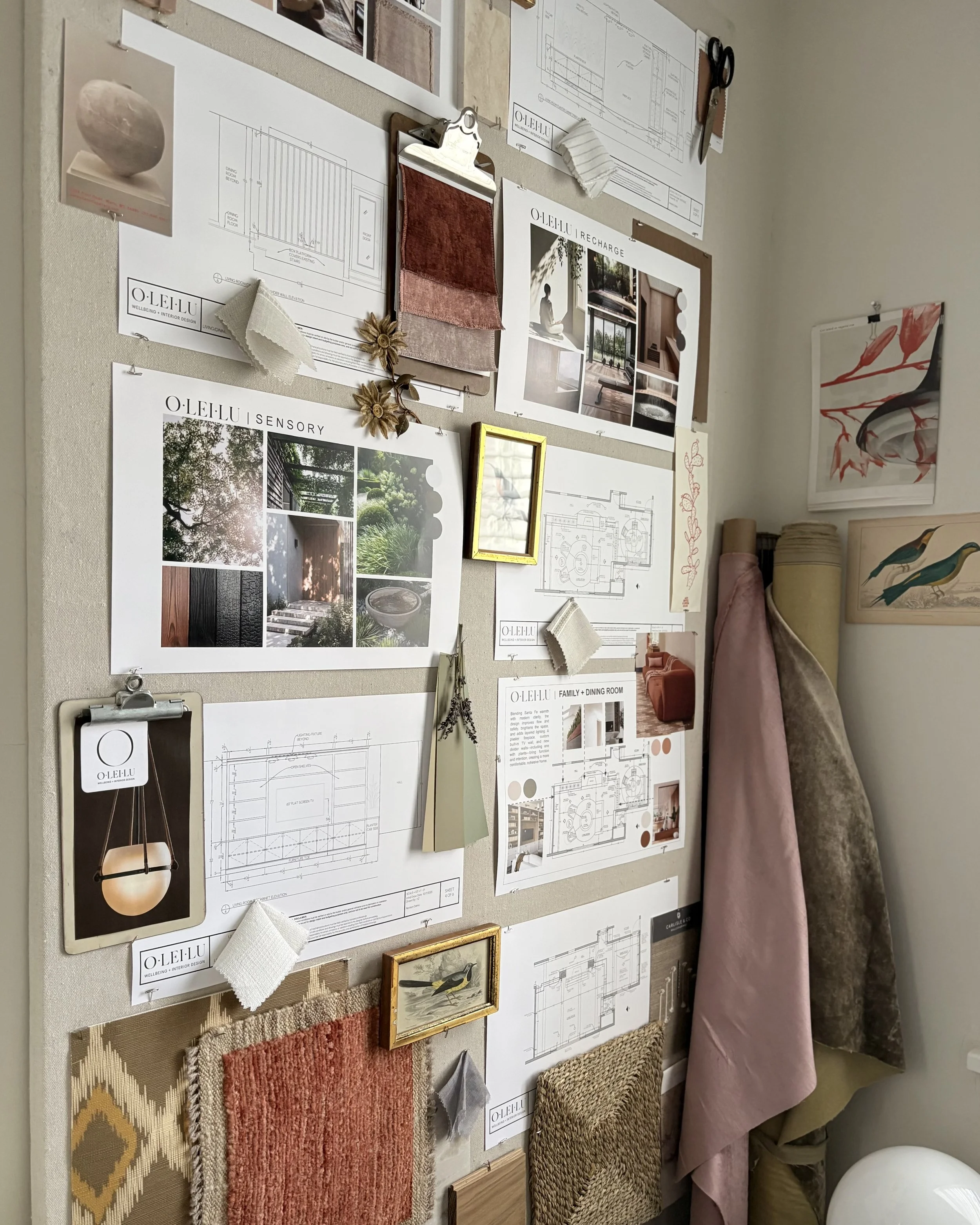 Open-concept living and dining area with large windows, modern furniture, and a kitchen with a white backsplash and island.