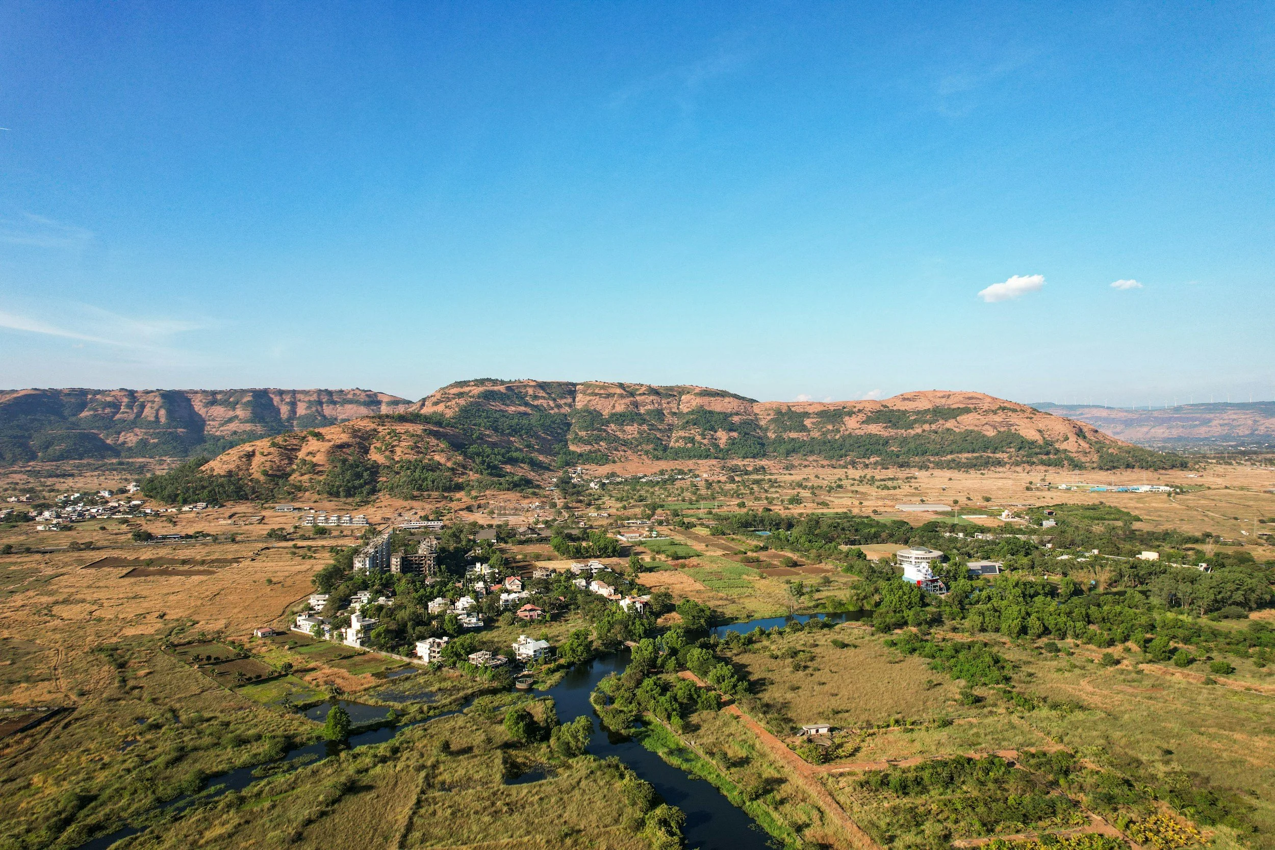 Birds Eye view of a valley with a mountain range in the background