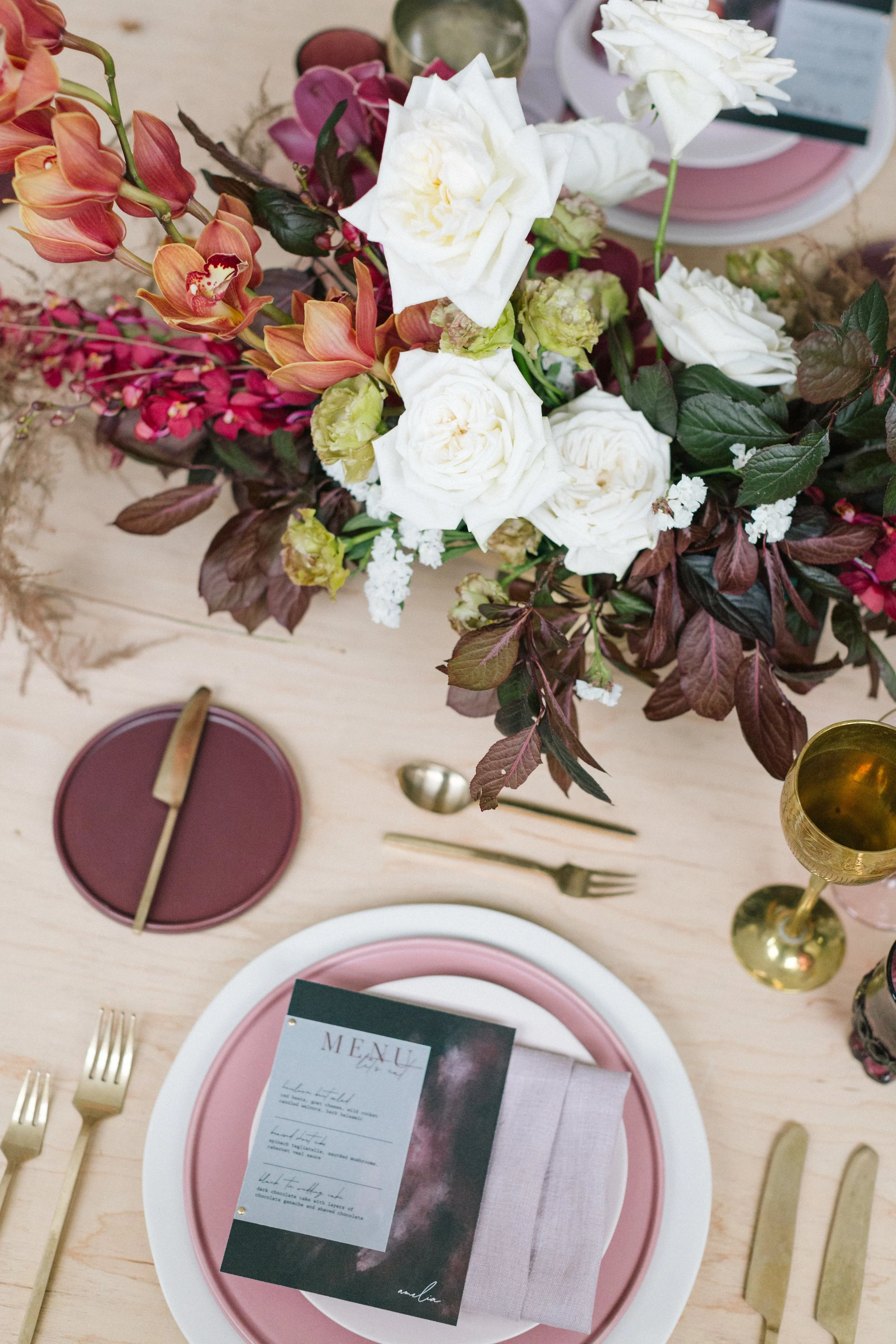 Moody cabernet and burgundy floral wedding design with rich seasonal tones.