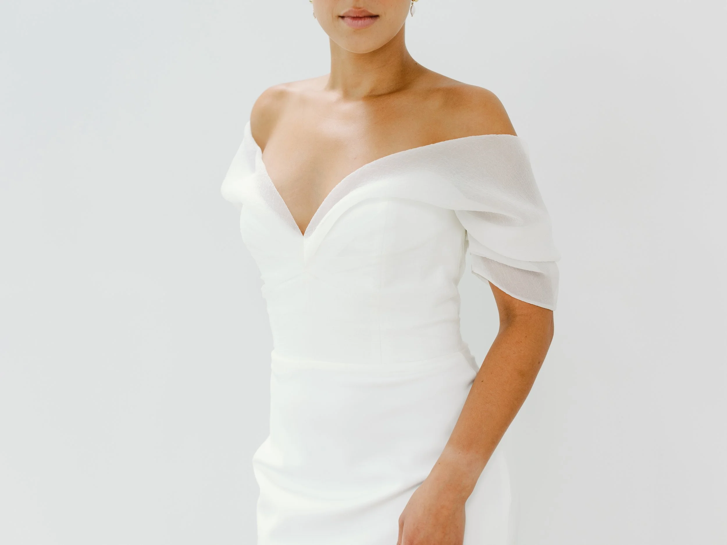 Basque waist bridal gown with gloves and a romantic sculptural veil