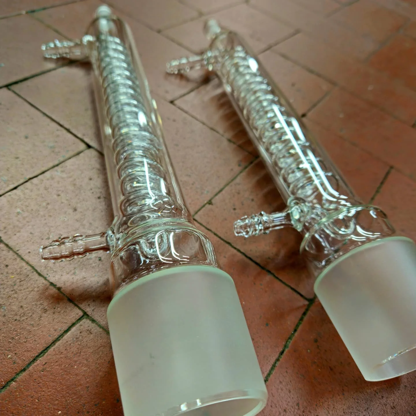 A pair of coil condensers made to fit into an existing assembly. 

#glassblowing #scientificglass #condenser #coilcondenser #distillation #research
