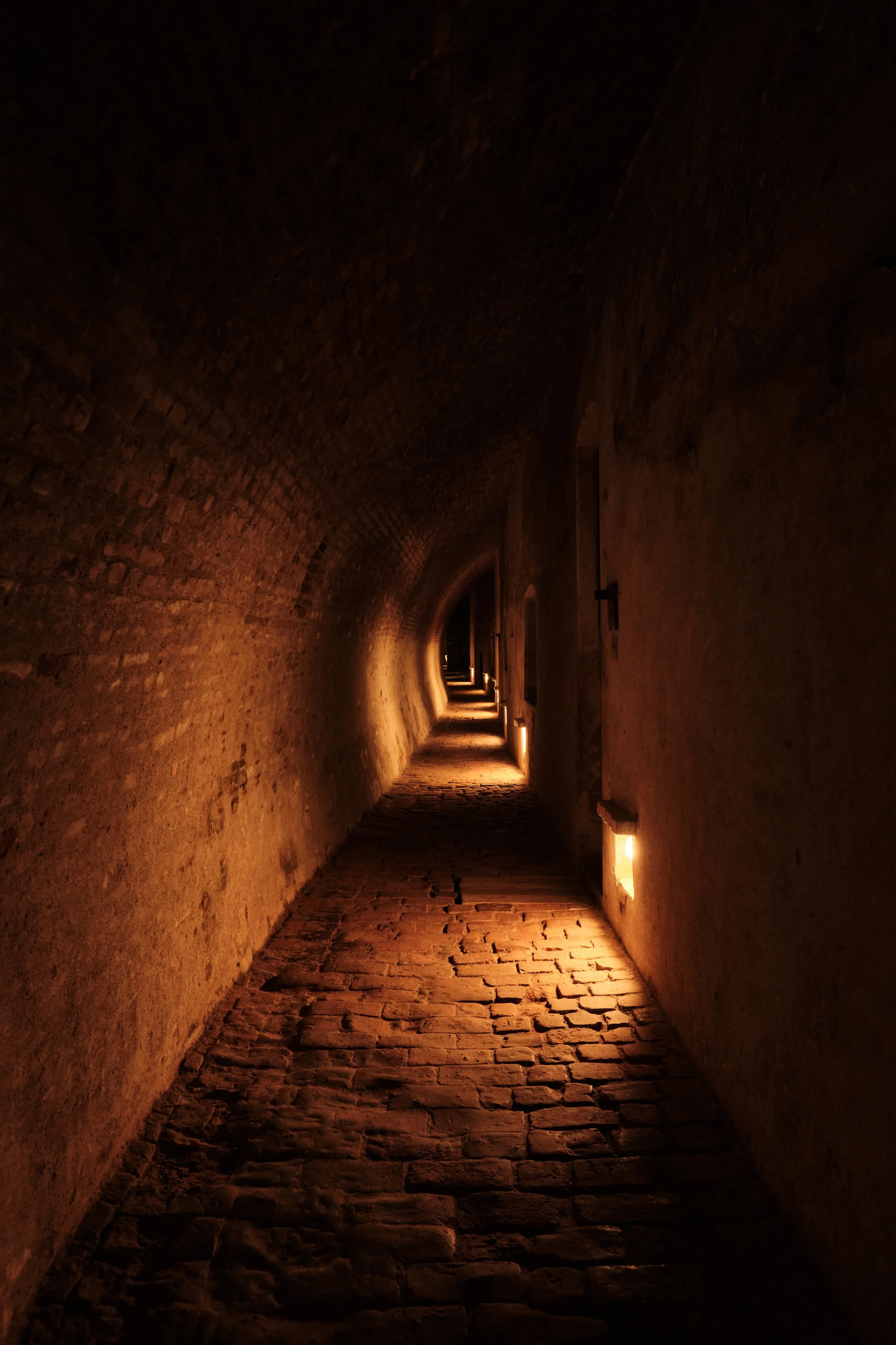 Echoes of Confinement -

Beneath Špilberk Castle, narrow corridors and prison cells preserve a chapter of Brno’s history that is difficult to forget. Walking through these silent spaces offers a glimpse into lives once defined by isolation, uncertain