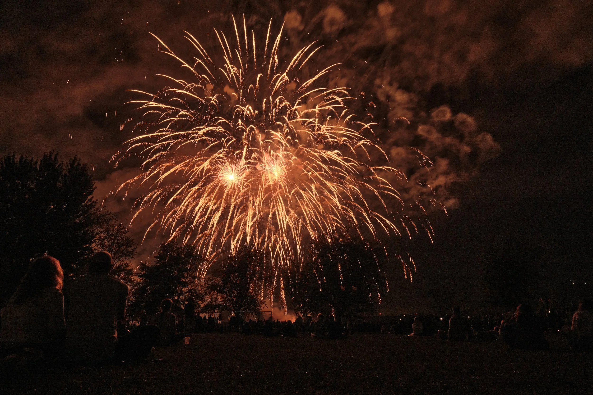 The first fireworks painted the sky in warm shades of gold, almost like falling embers. Moments later, the night transformed into clouds of vivid artificial color, turning an ordinary summer evening in Magog into an unexpected spectacle.