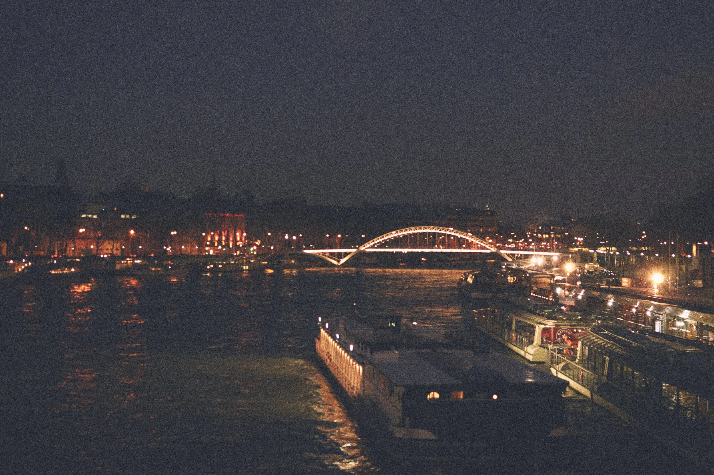 Paris after dark felt timeless through the grain of these photographs. The Seine reflected the city’s lights while the Eiffel Tower glowed in the distance, reminding me that not every memory needs perfect clarity. Sometimes the imperfections are what